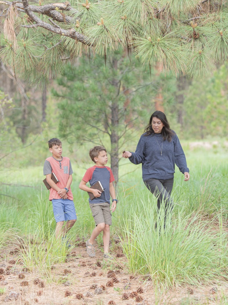 Chelsea Day walks through a forest with her children
