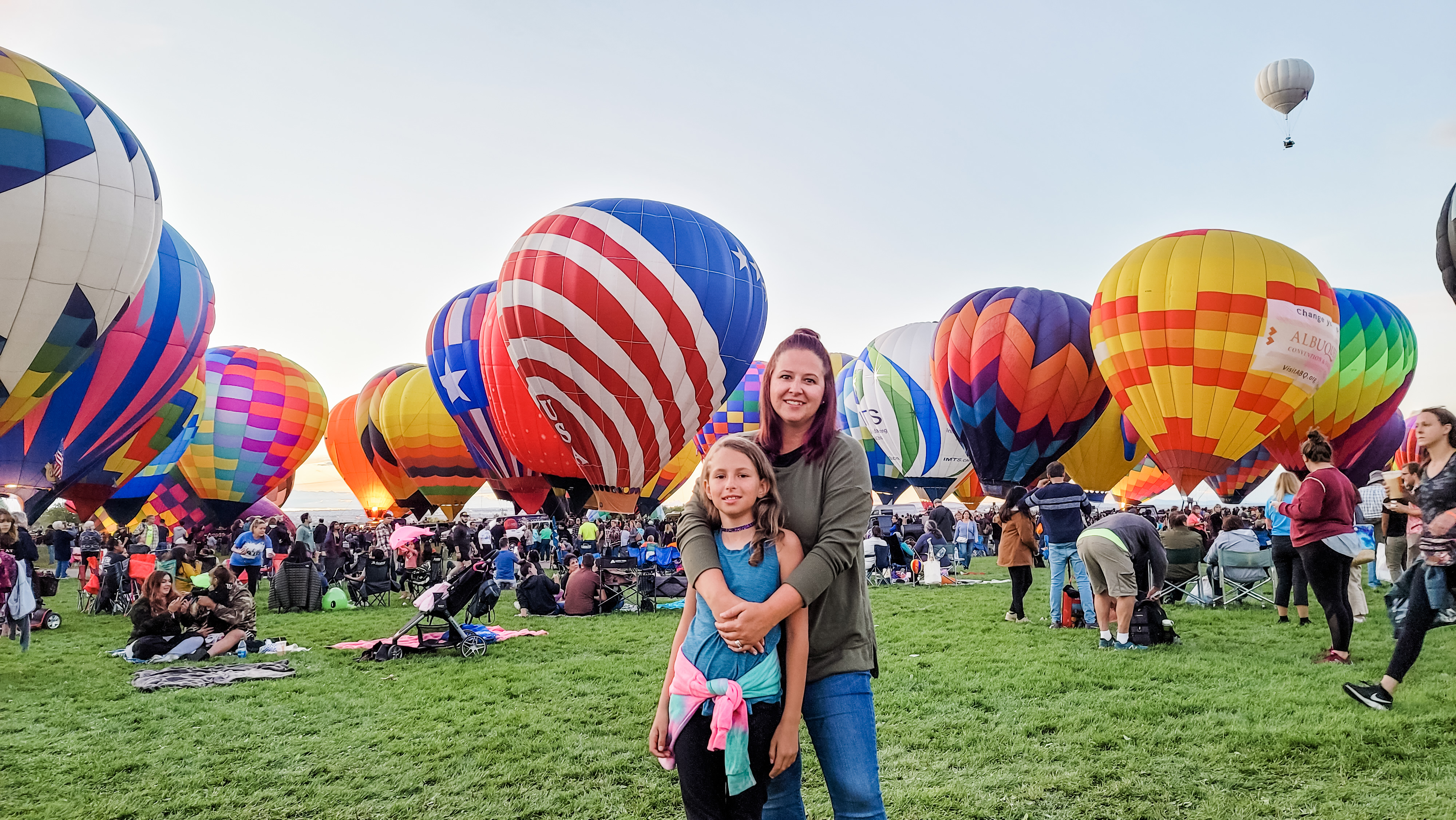 KAYLEE TECHAU and her daughter smiling for a photo at a hot air balloon festival 
