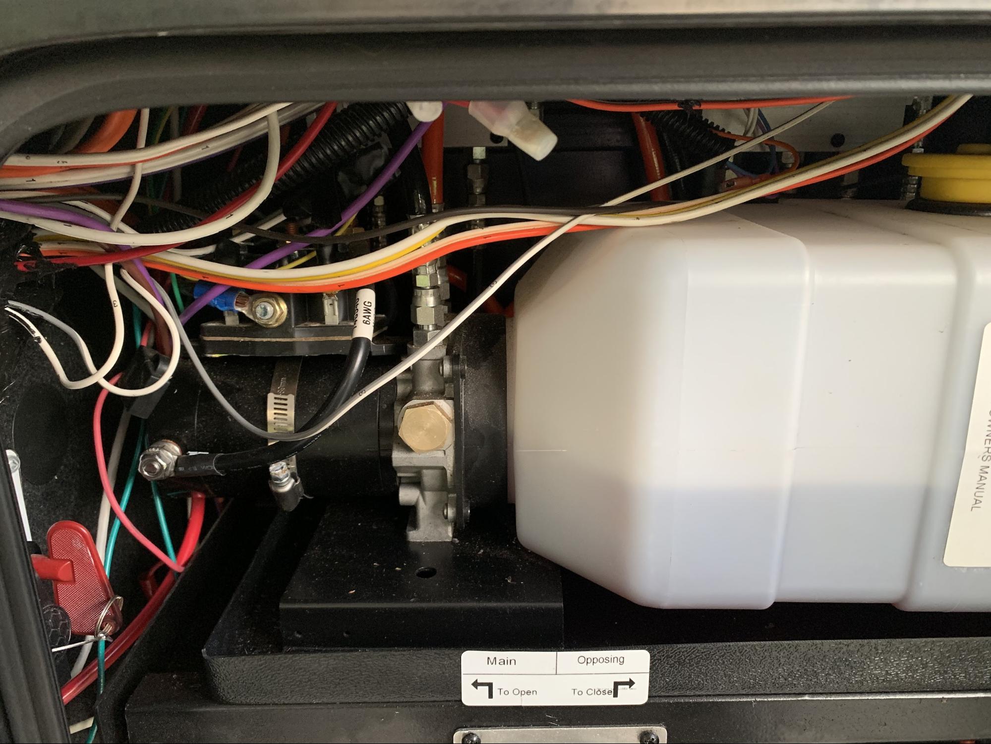 Tom Boswell showing where to check for the levels of a hydraulic reservoir. 