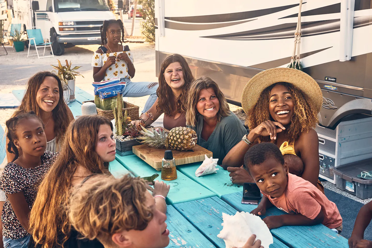 The Lane family and their friends sit around a picnic table 