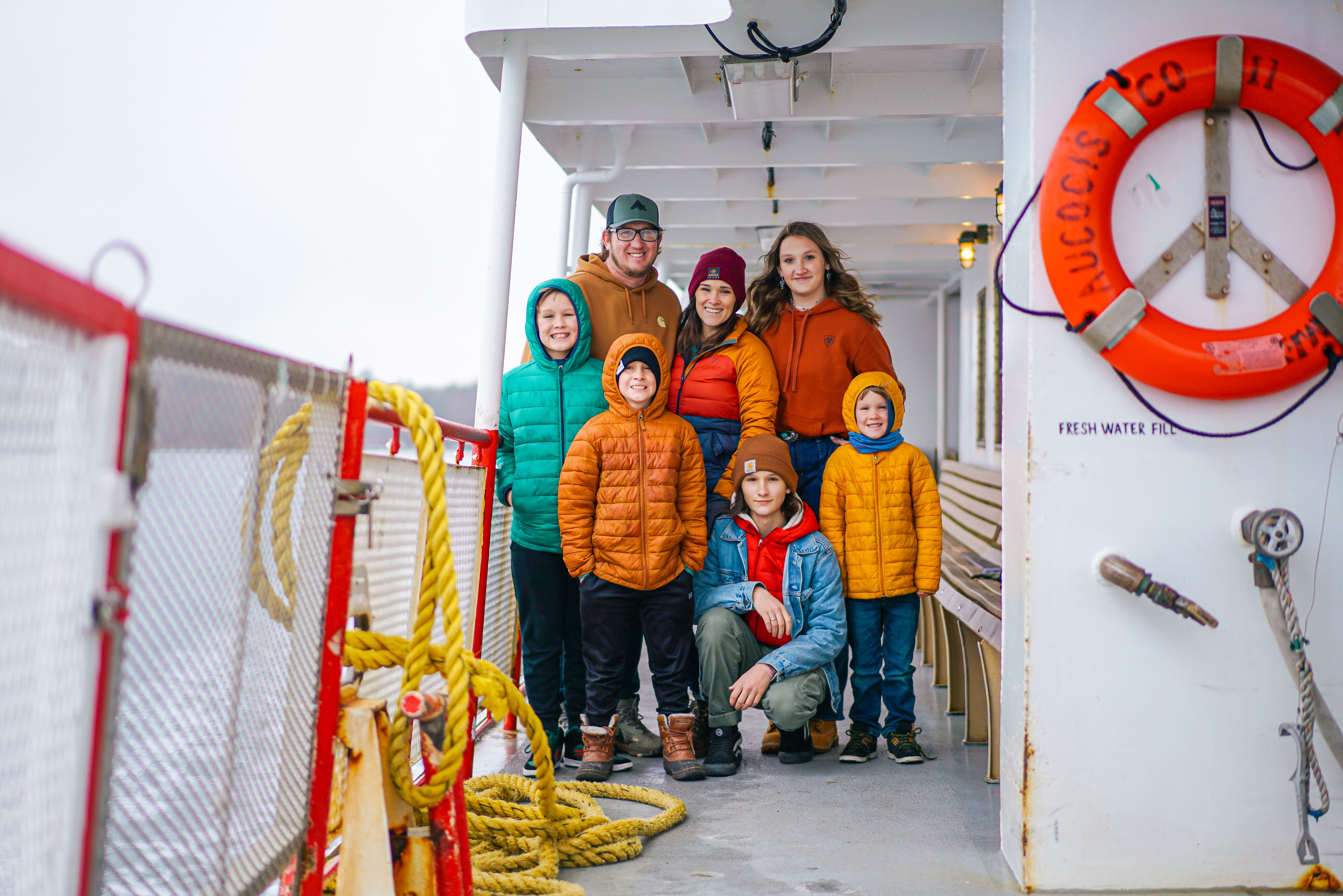 The Renee and Shaun Tilby family pose on a ferry boat in Portland, Maine.