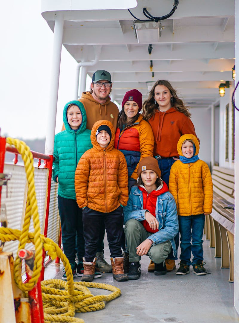 The Renee and Shaun Tilby family pose on a ferry boat in Portland, Maine.