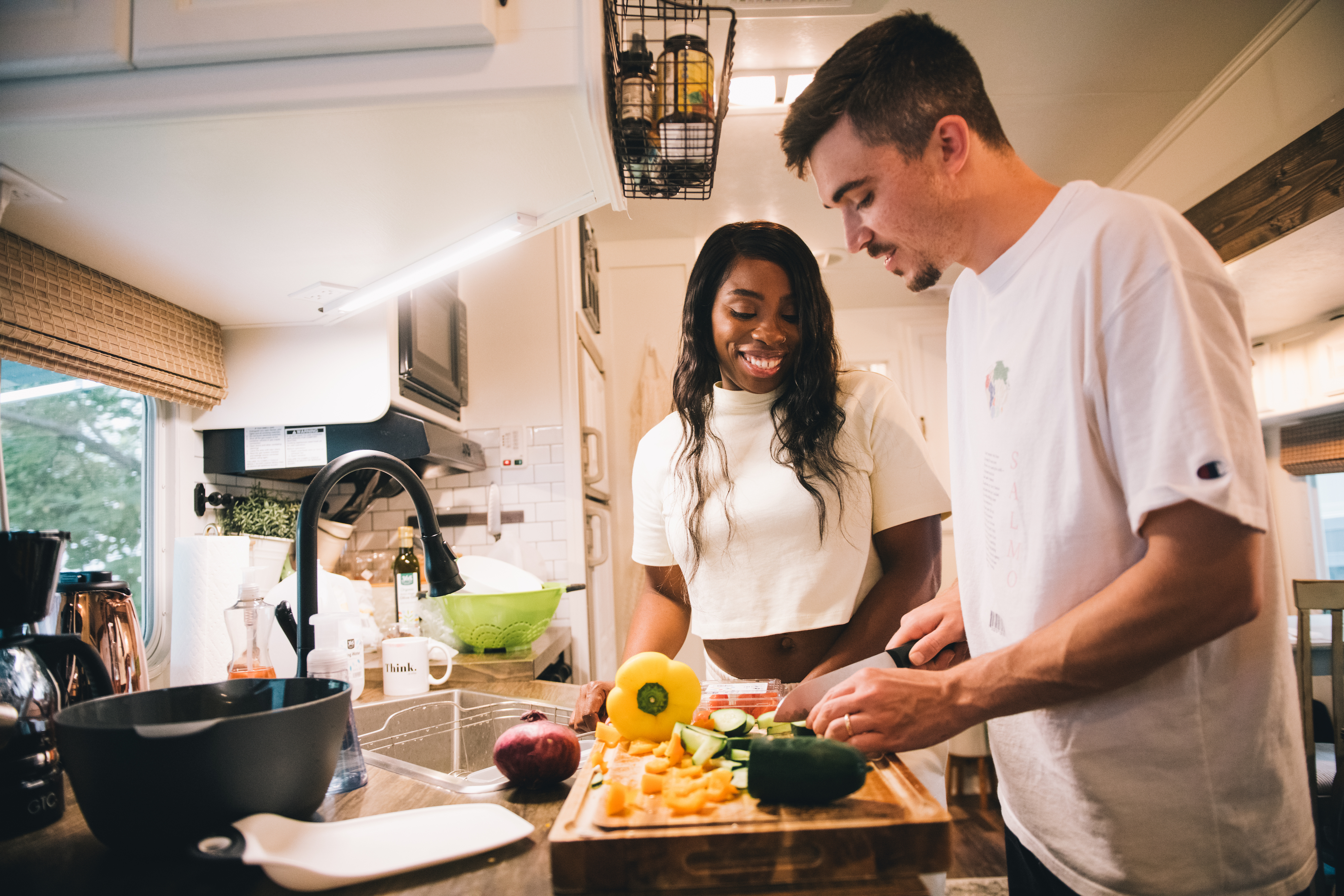 Jessy and Jim cooking inside their Keystone Cougar