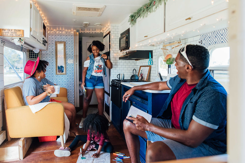 A teenage girl dancing and making her parents laugh inside an RV.