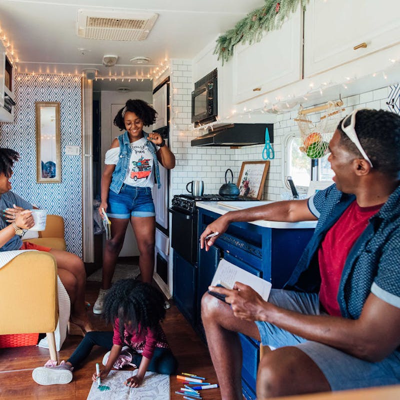 A teenage girl dancing and making her parents laugh inside an RV.
