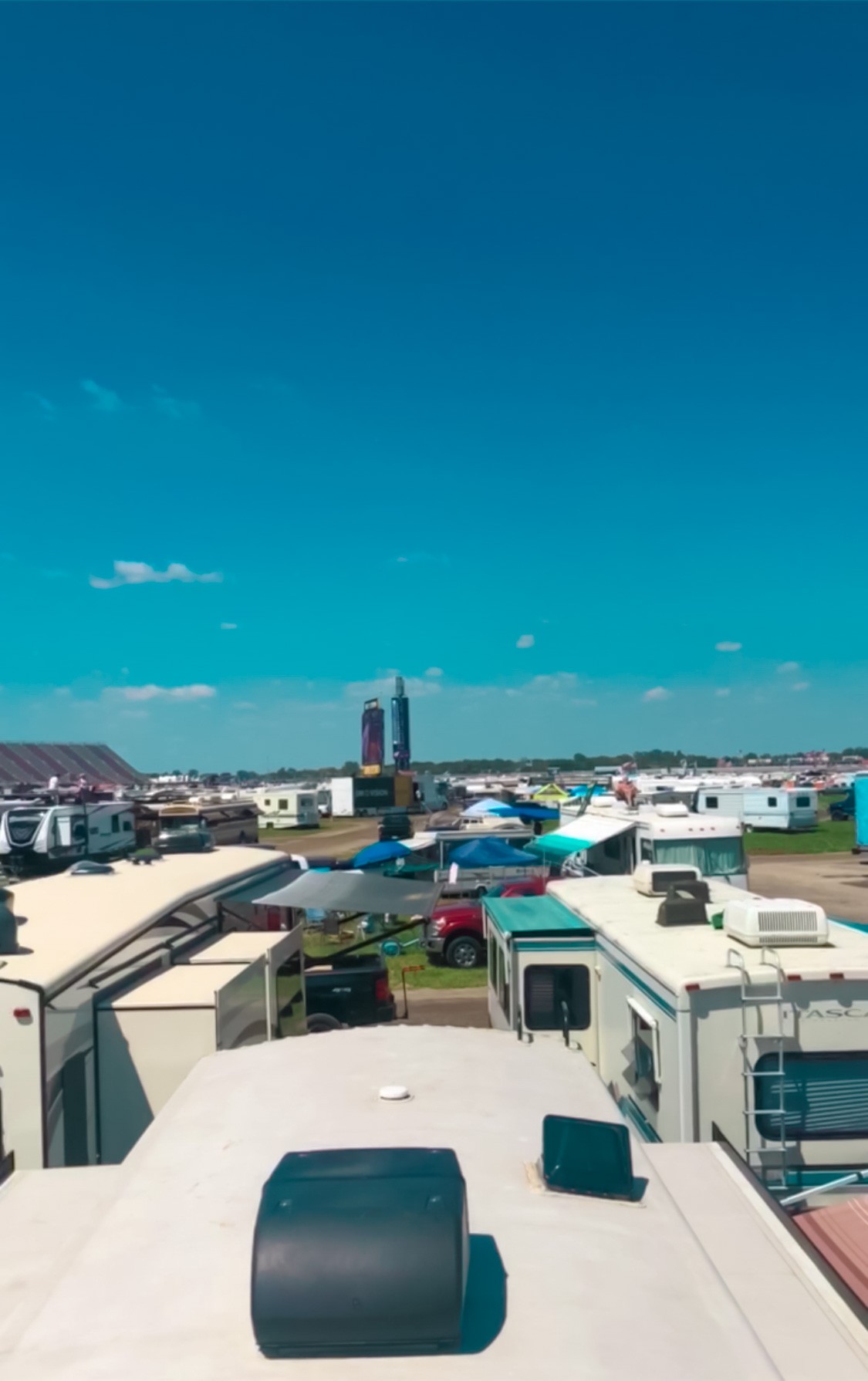 A rooftop view of multiple RVs parked at a NASCAR Race