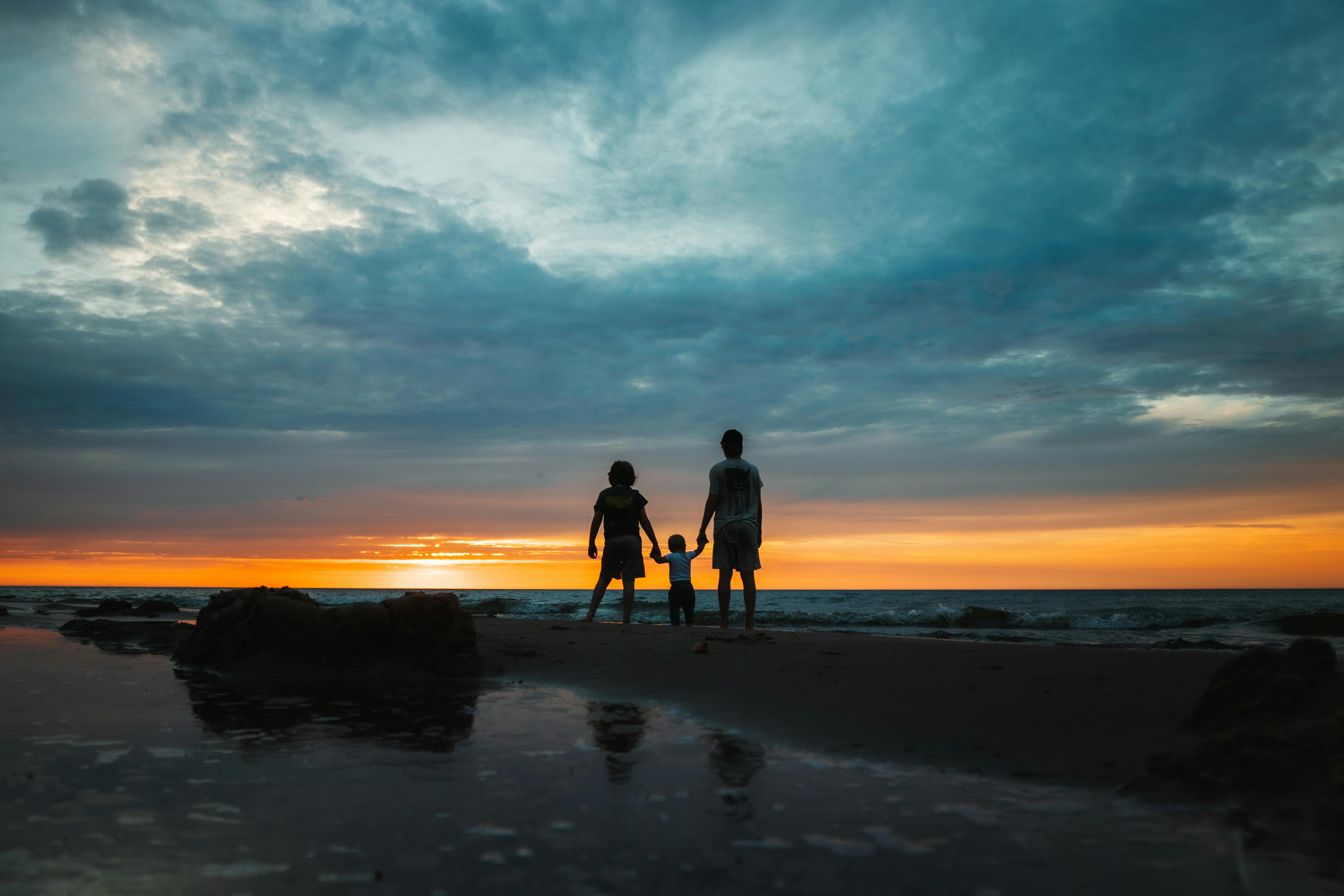 The Andy and Kris Murphy family watching the sunset over Lake Michigan at Huron-Manistee National Forest.