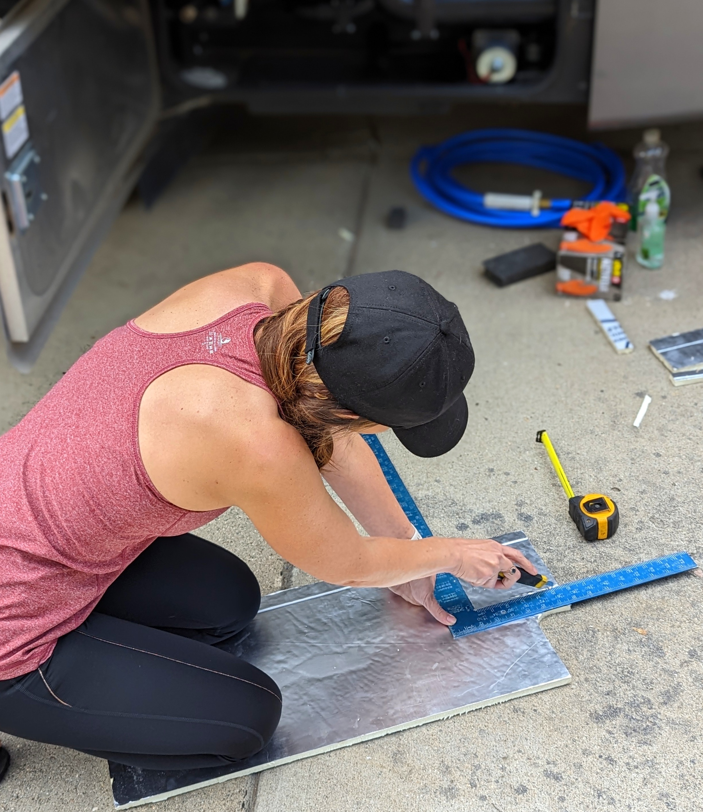 Sarah Bauer measuring and cutting insulation for her RV