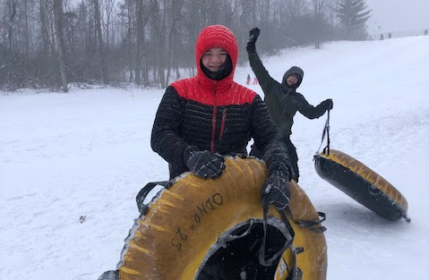 Two boys snow tubing at Punderson State Park.