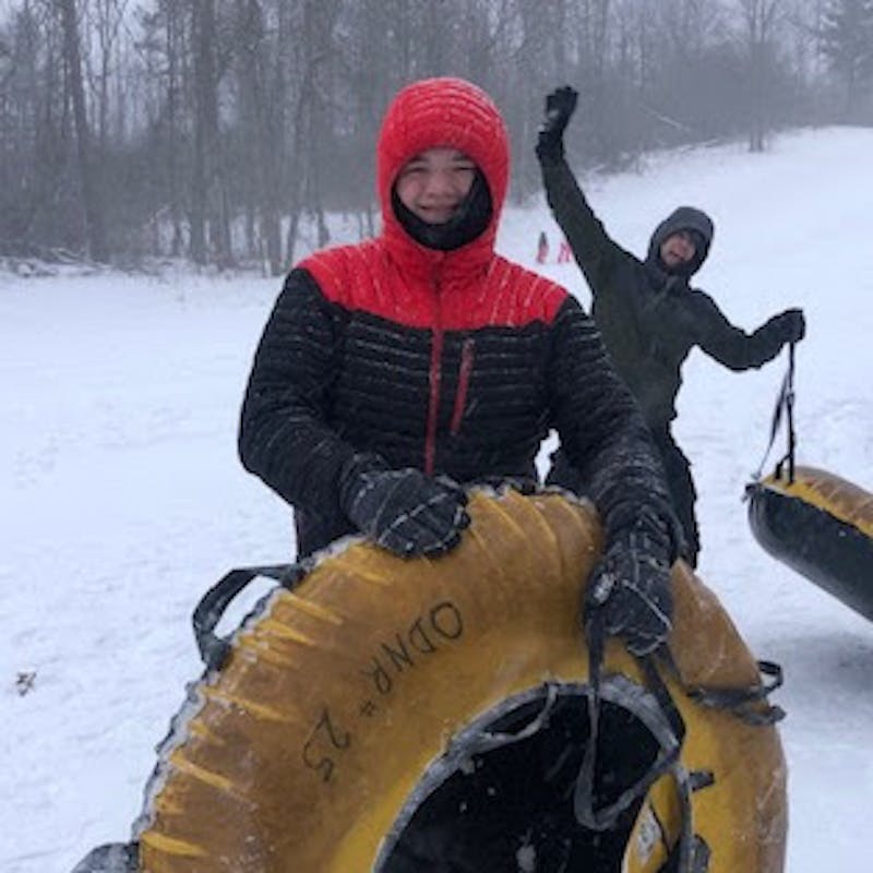 Two boys snow tubing at Punderson State Park.