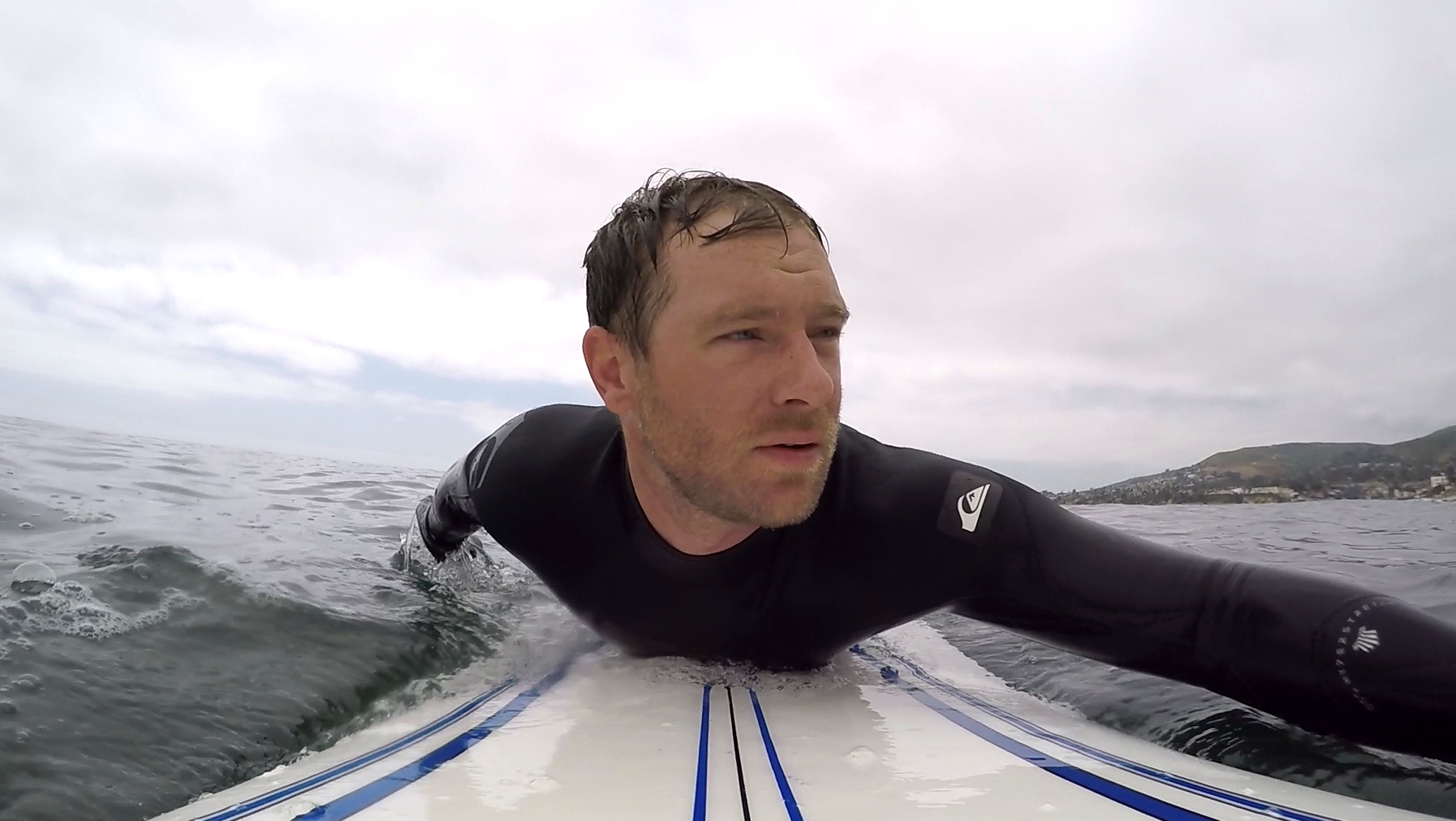 Eric Hannan paddling out to surf.