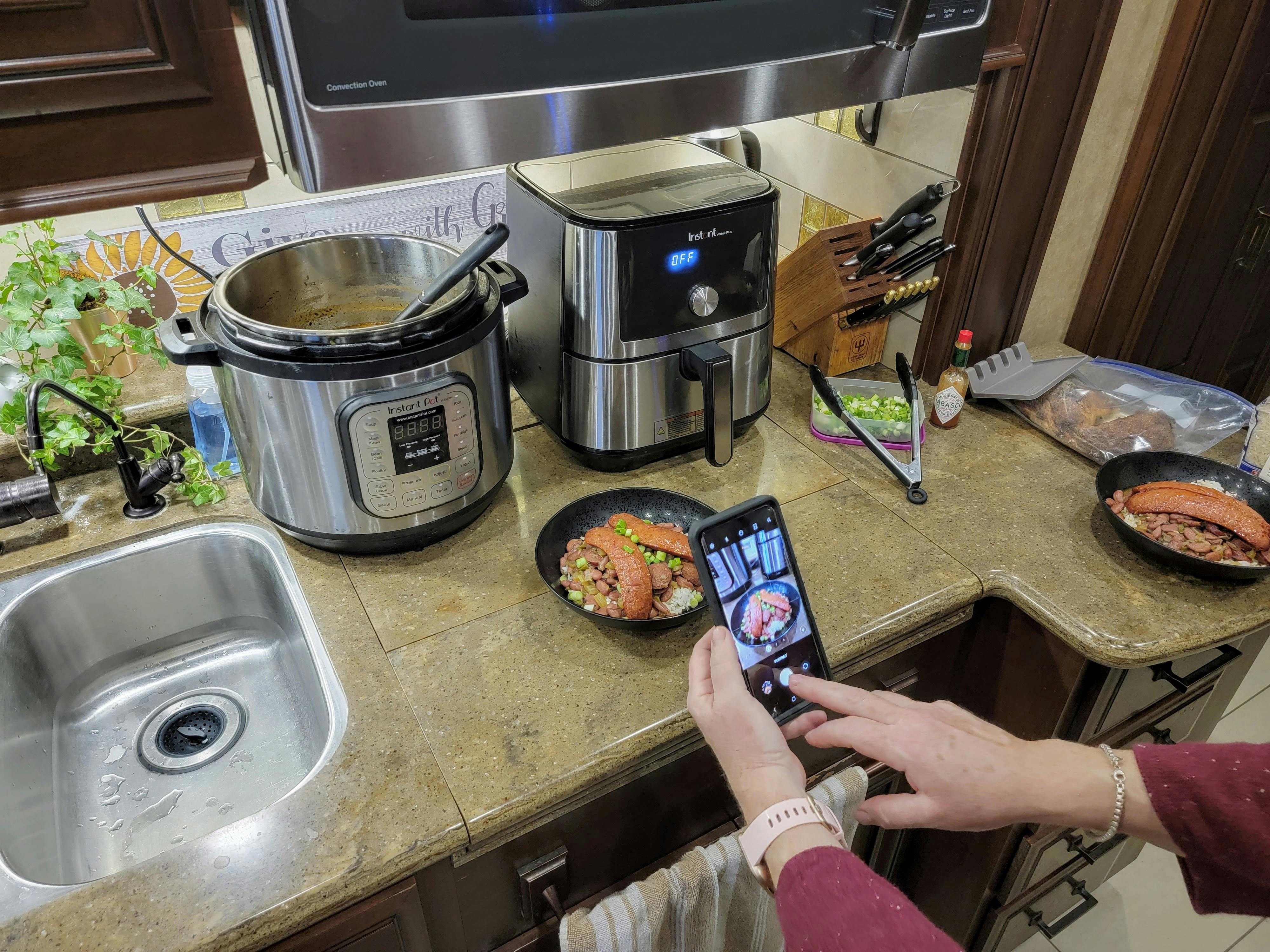 ANNE KLUMPP taking a photo of a meal inside her Class A RV
