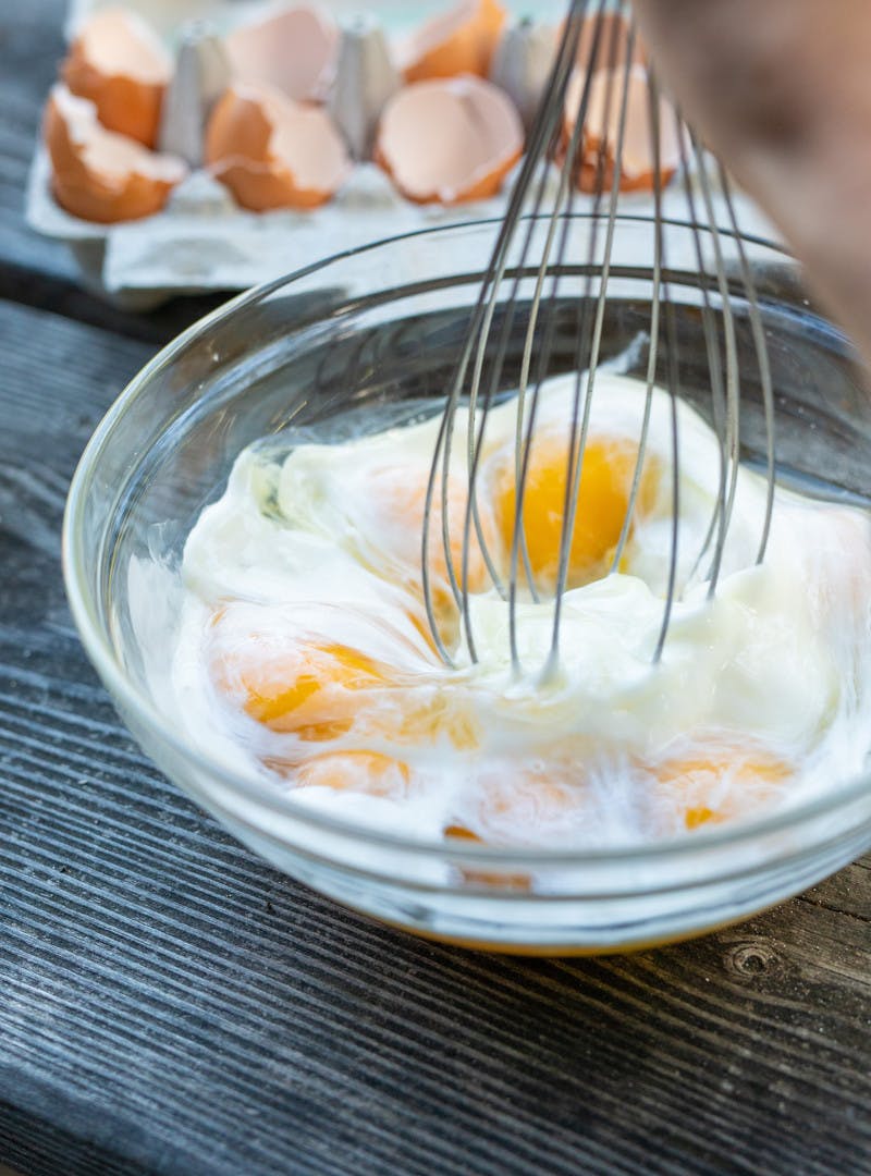 Eggs in a bowl being whisked.