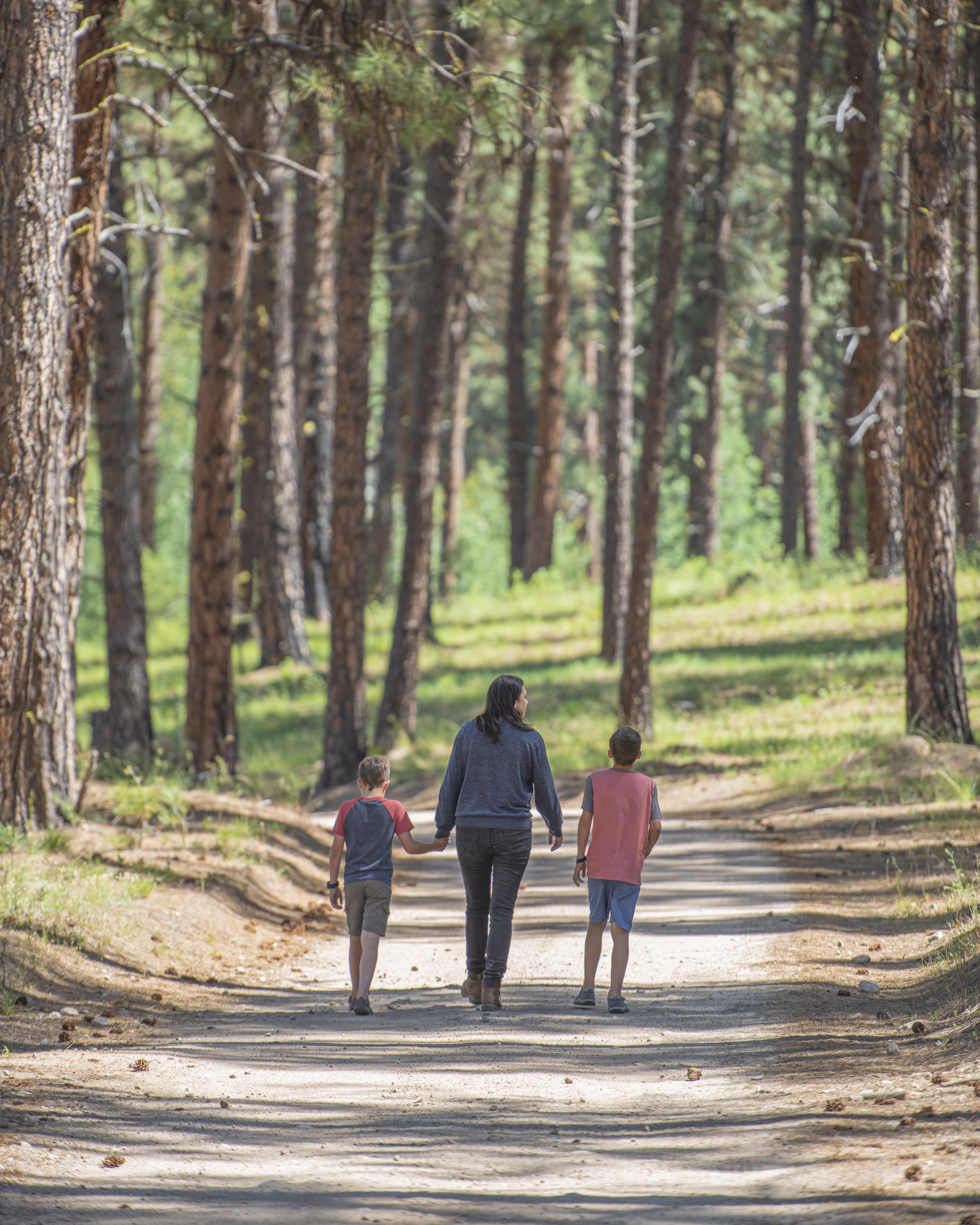 Chelsea Day and her children walking down a bath in the forest