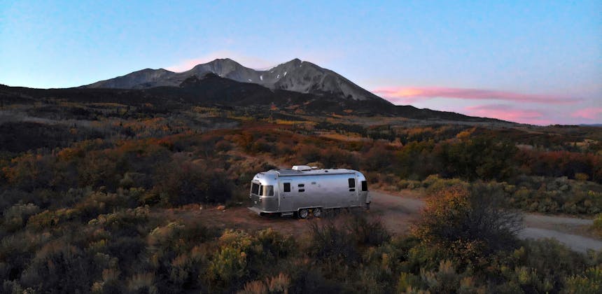 Stacey Power's Airstream parked in a boondocking camping spot overlooking the sunset