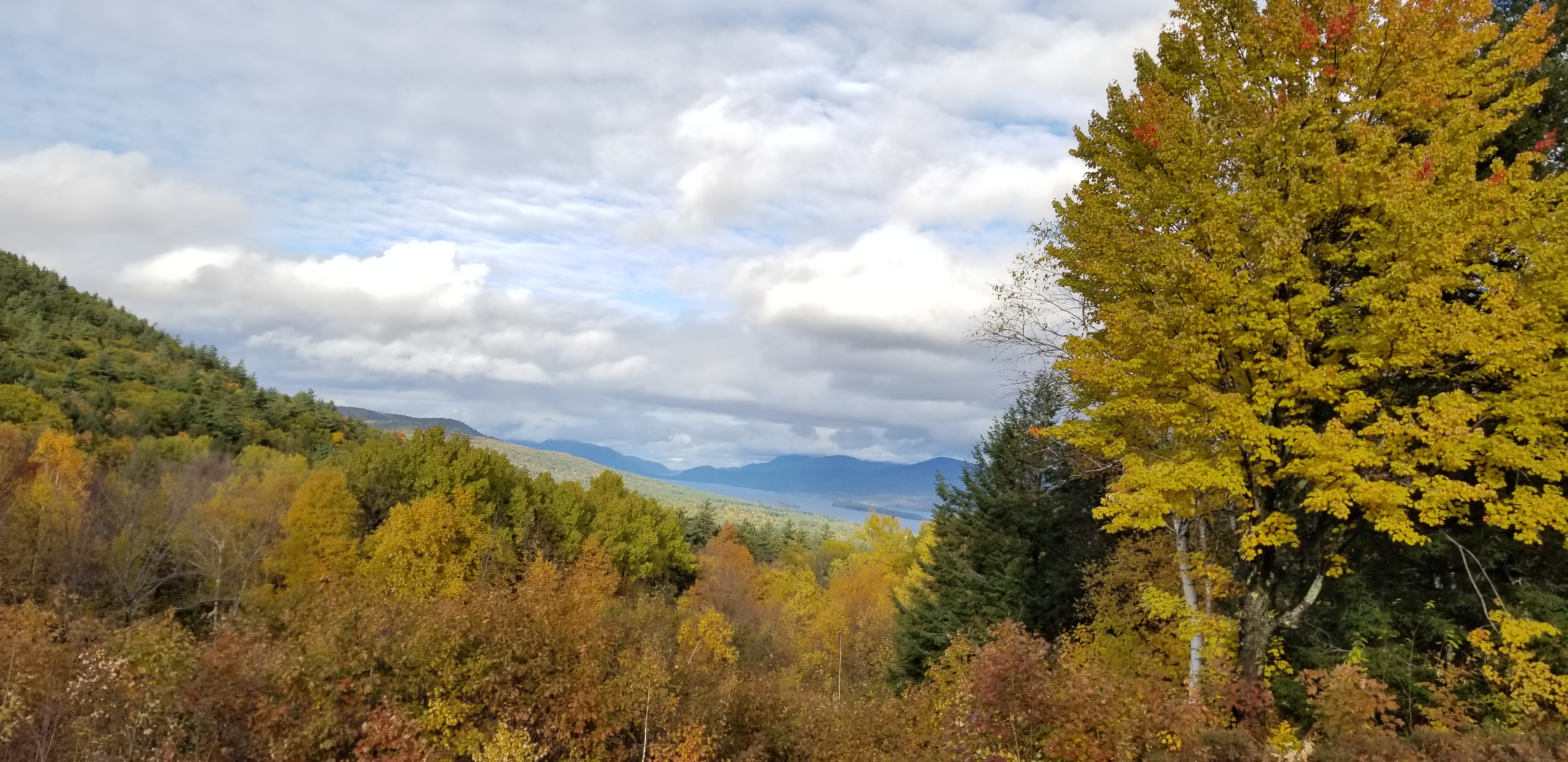 View of orange trees and clouds from the top of Prospect Mountain, New York