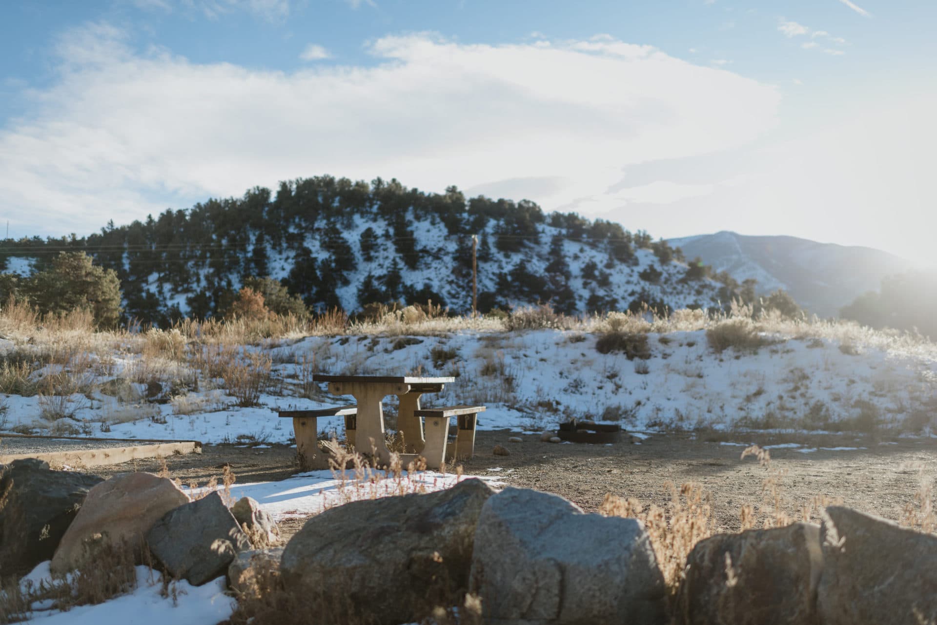 Spring camping prep snowy campsite with picnic table