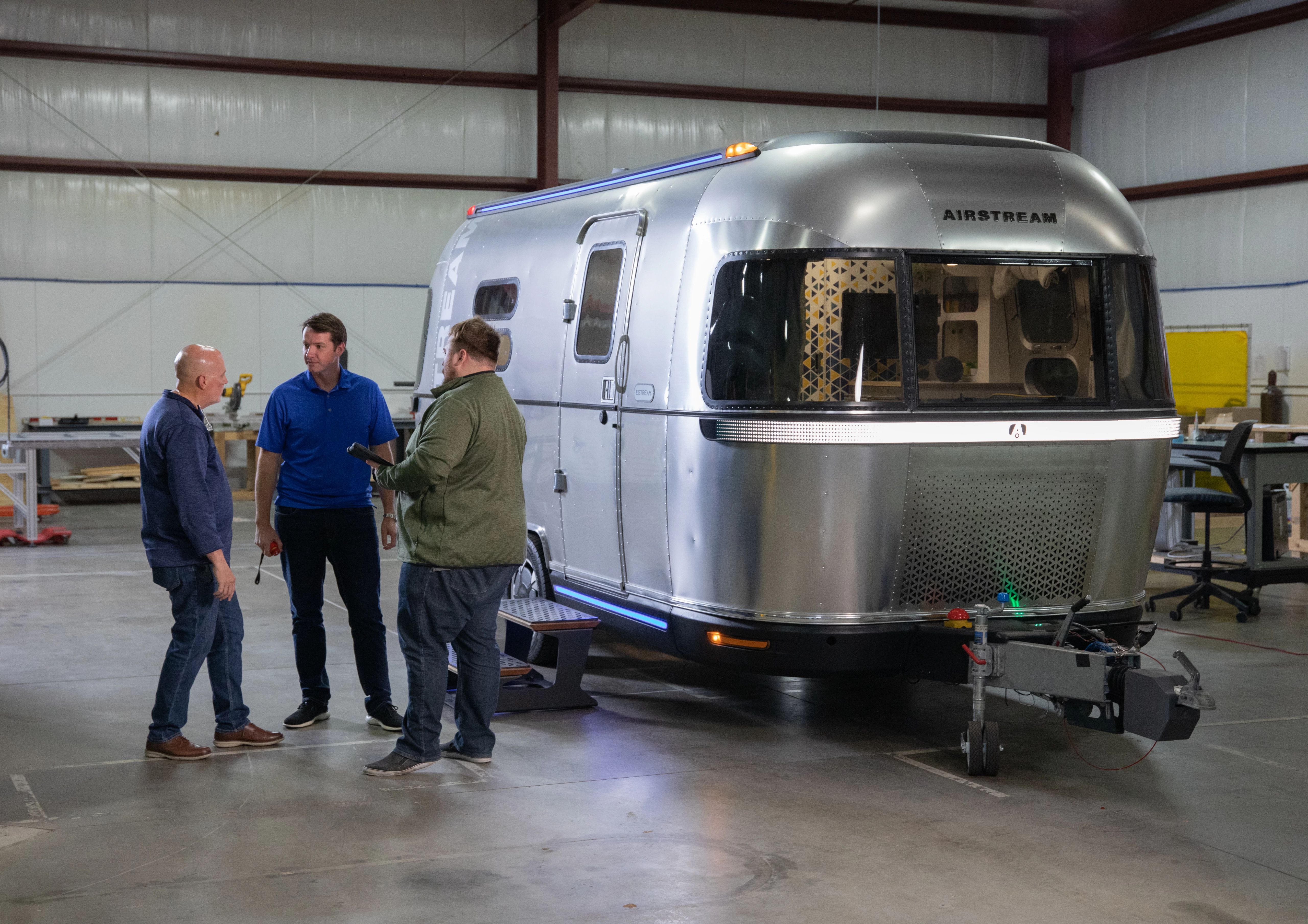 A group of men chatting next to THOR's E-Stream