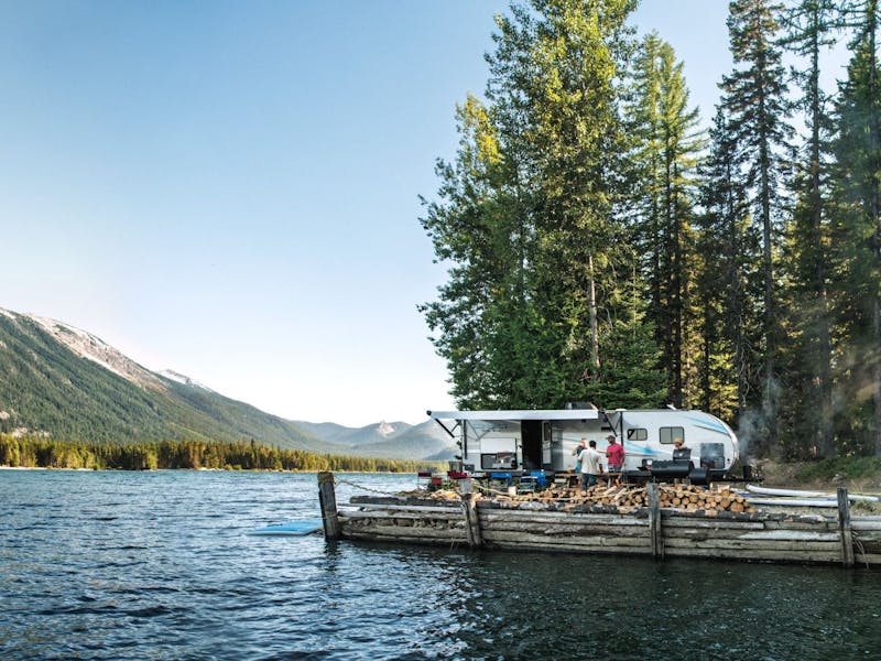 A KZ connect travel trailer camping near a lake in the pacific north west