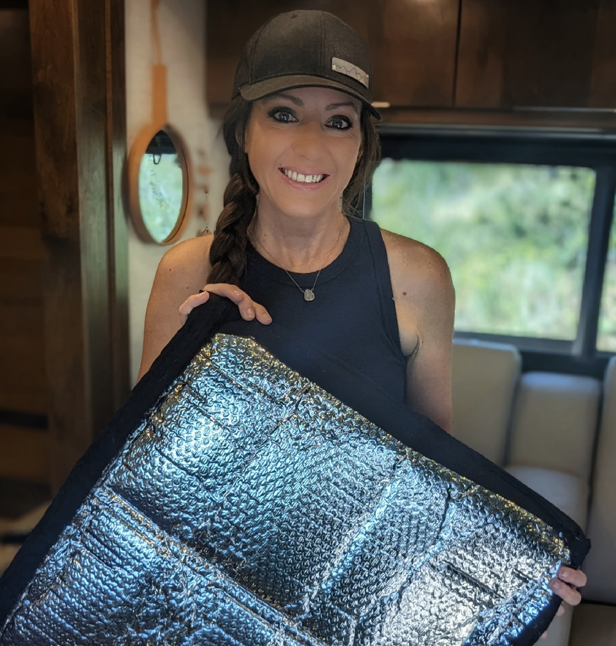 Sarah Bauer holds up a reflective window cover