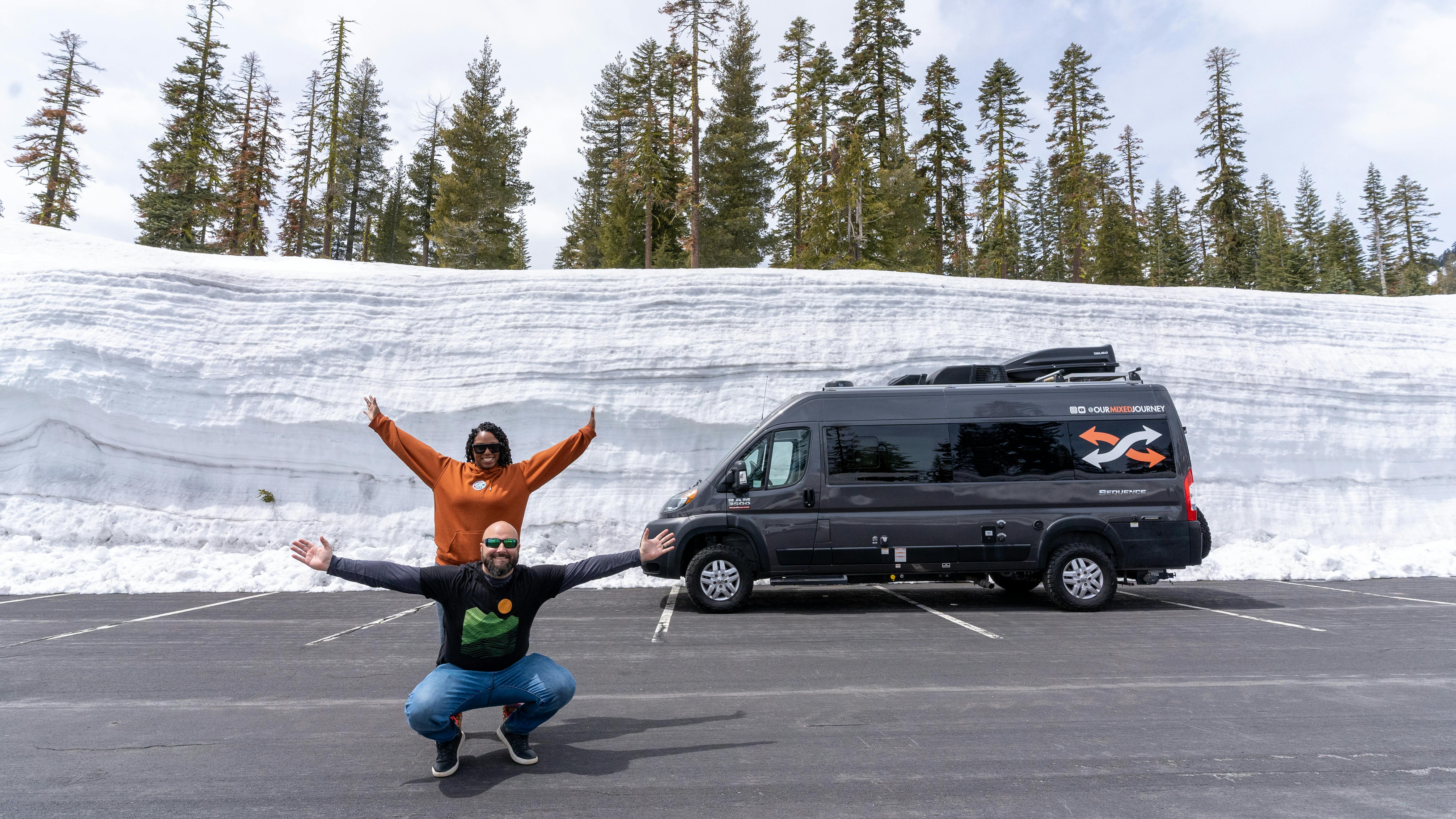 Gabe and Rocio Rivero posing for a picture in front of a snowy road