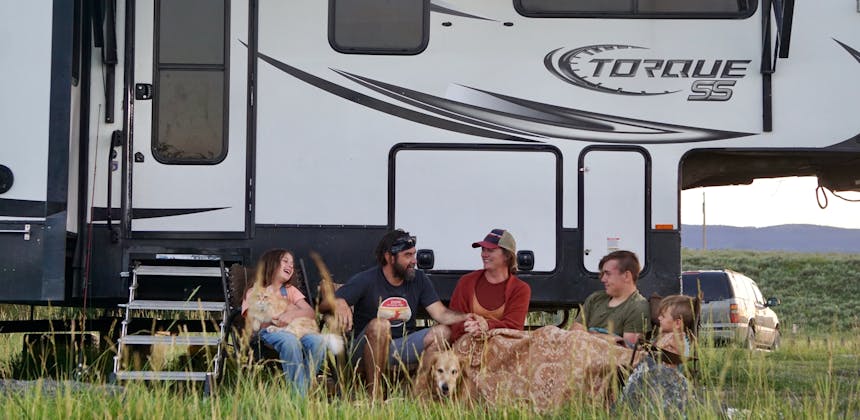 The Melissa and Lucas Lahr family gather outside of their Heartland Torque Toy Hauler.