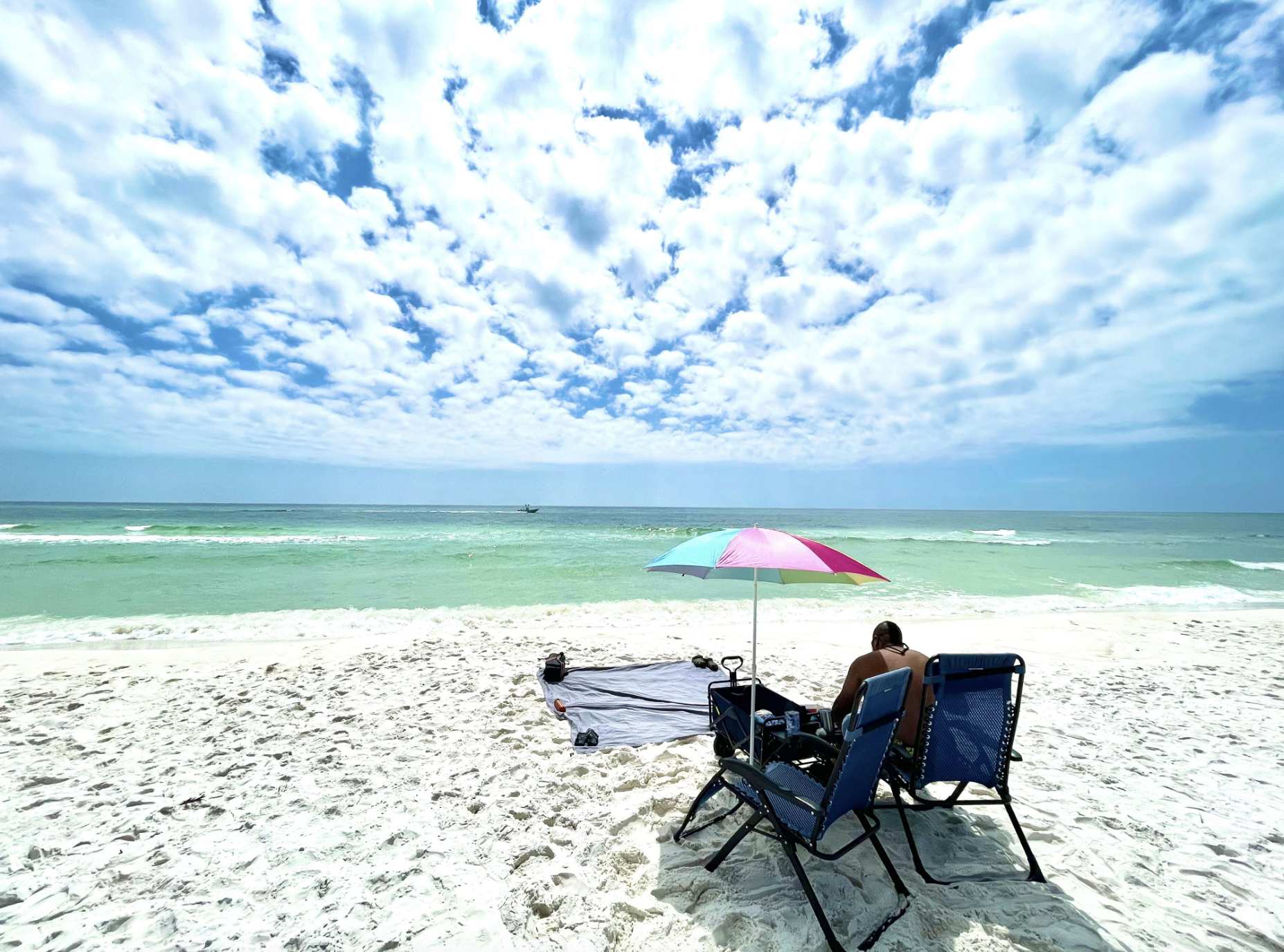 Ben McMillan sitting in a chair at a sandy beach near Fort Pickens in Pensacola, Florida.