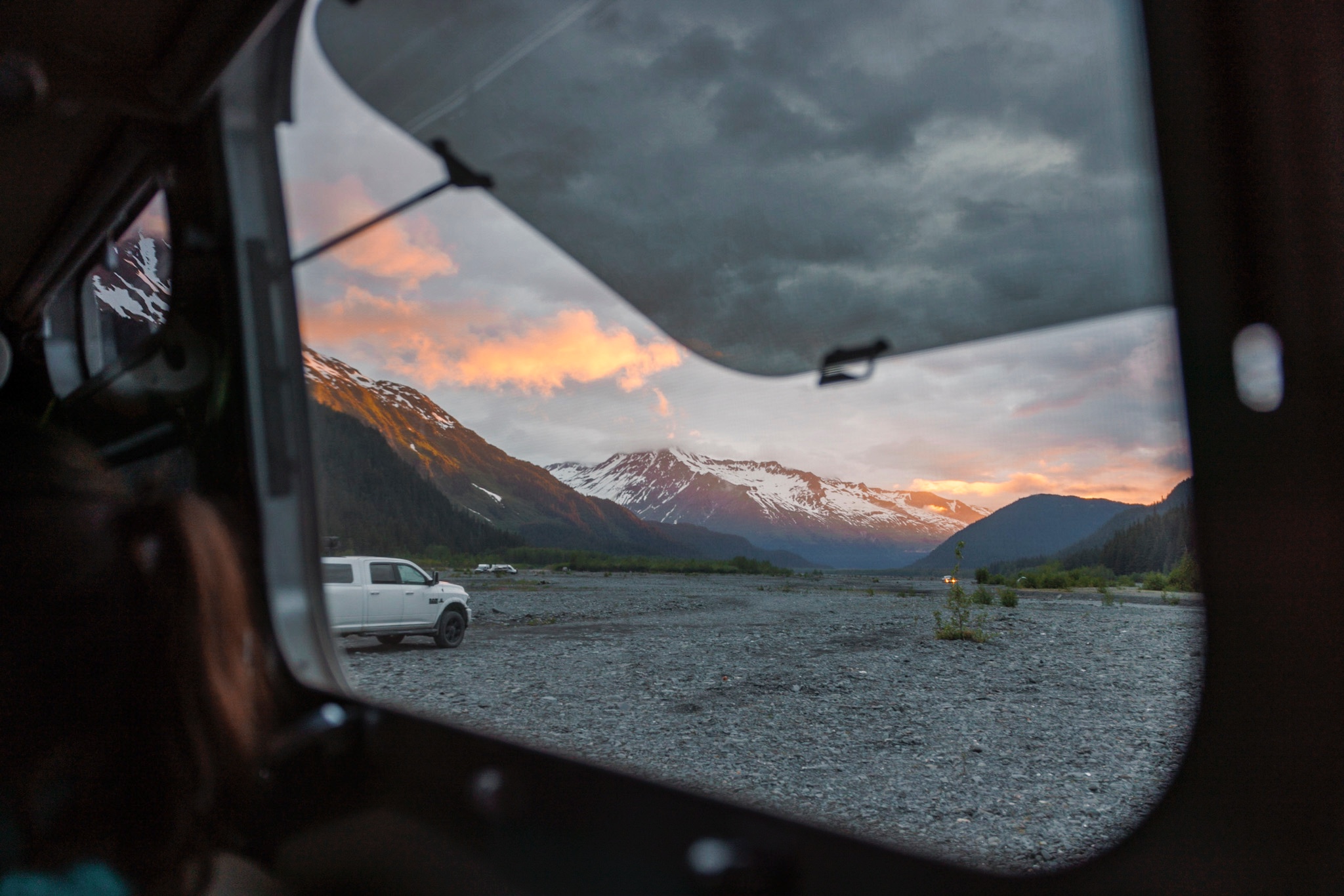 Looking outside the window of Karen and Lenny Blue's Airstream Flying Cloud at a mountain range 