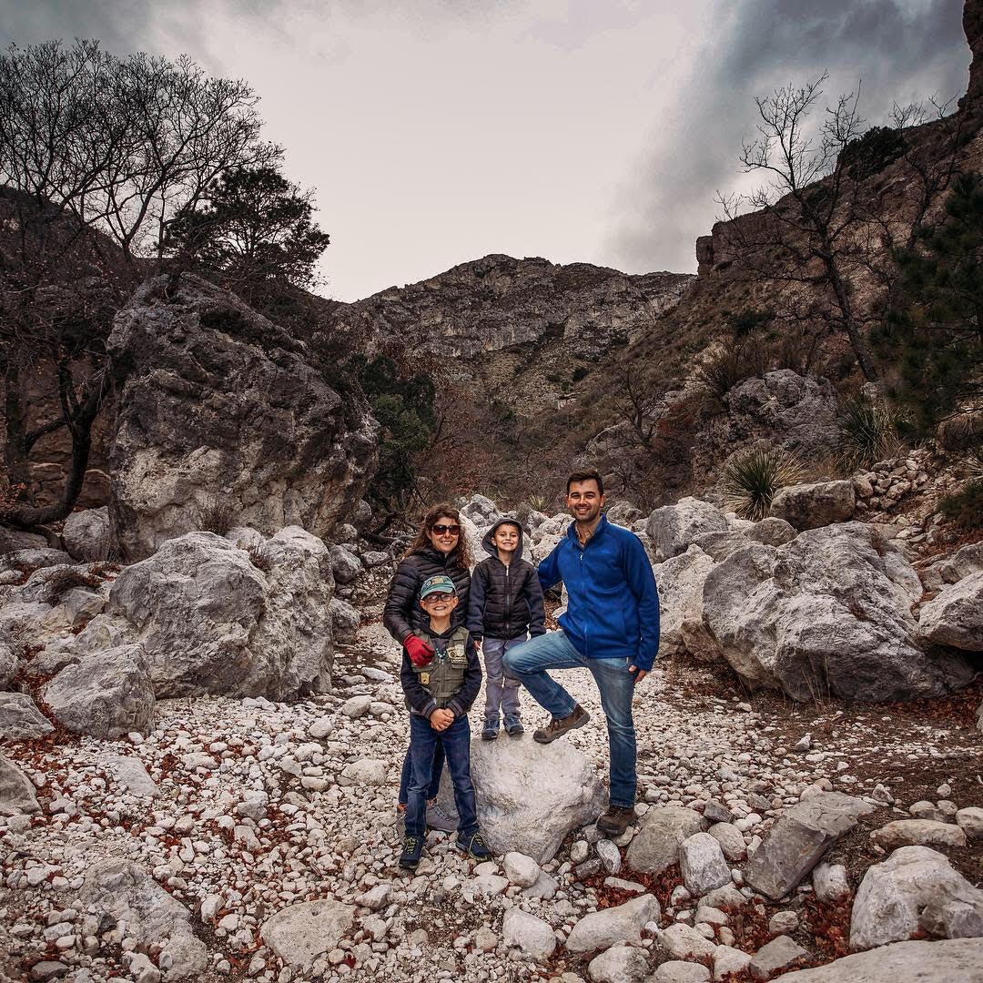 The Selm family posed for a portrait on a rocky hillside. 