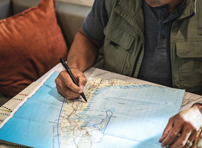 A man marking a map with a pen