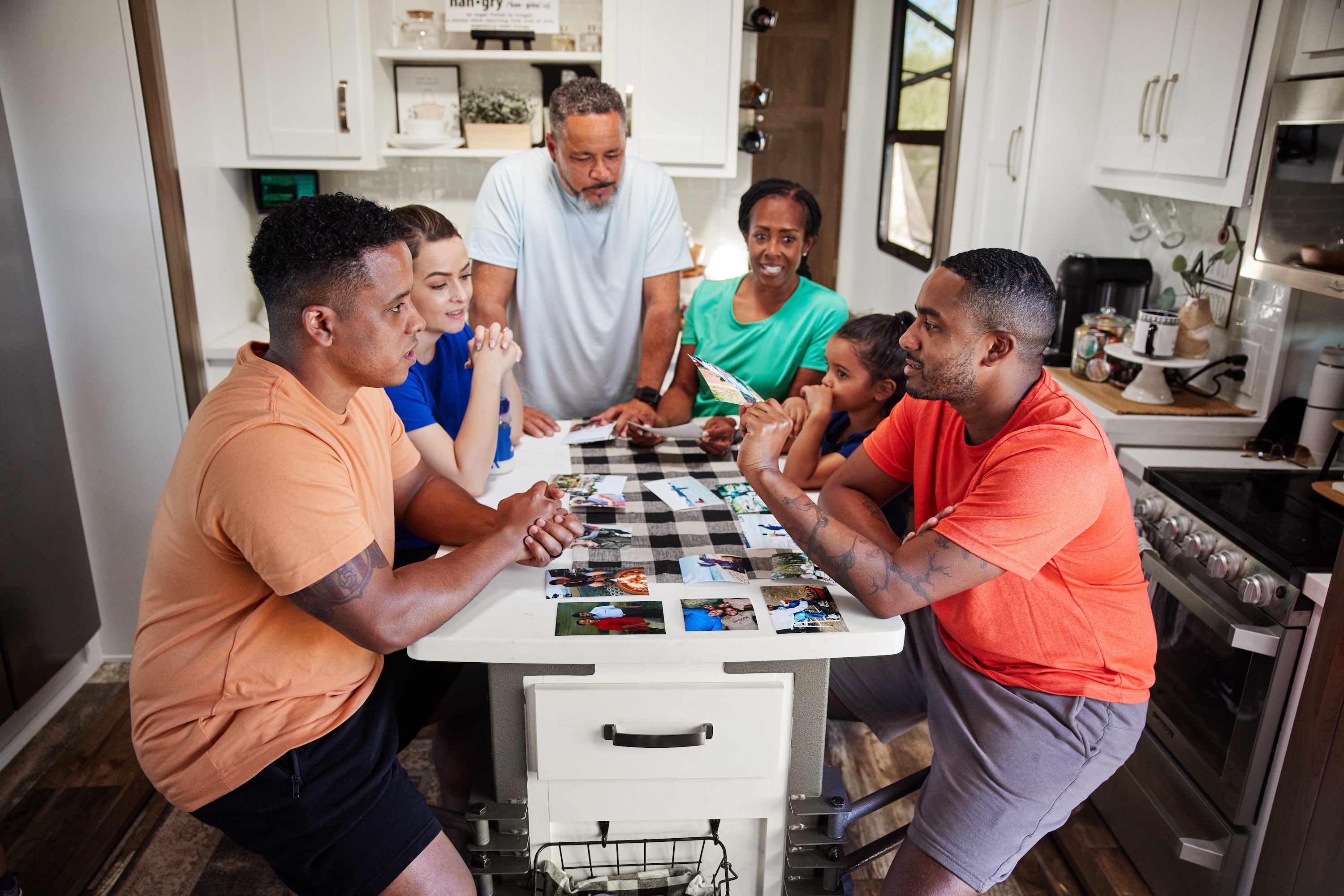 Robin and Warren's family sit around the island in the kitchen of their Keystone Fuzion.