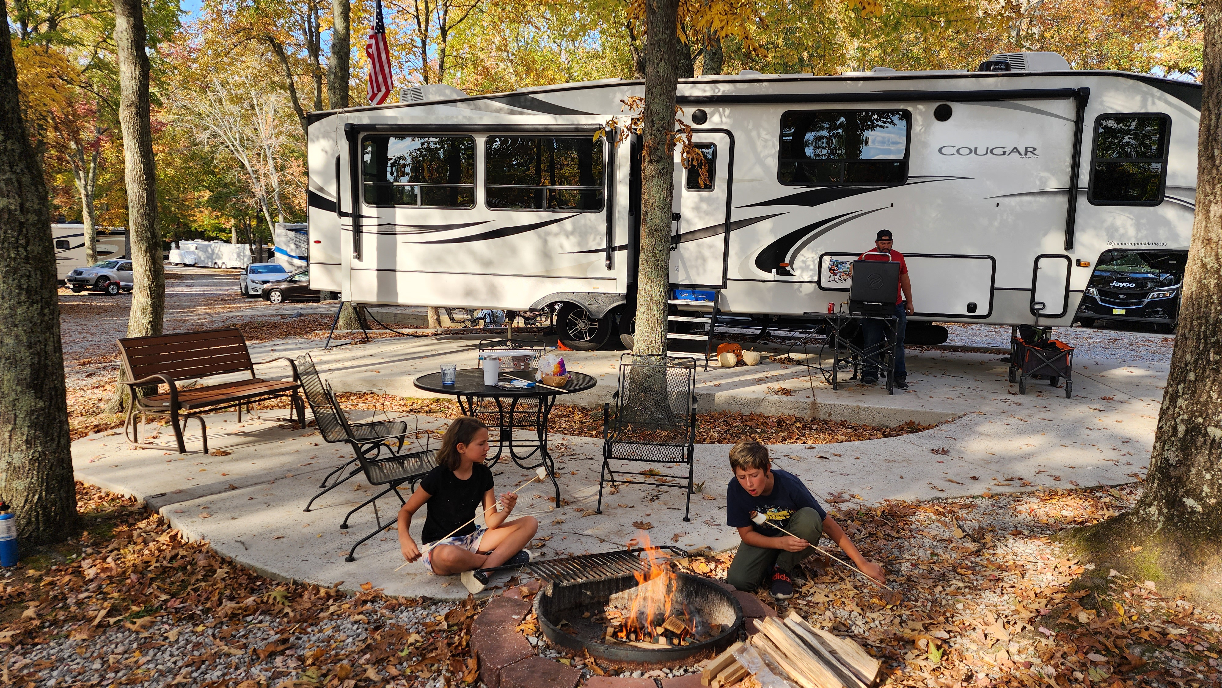 STEVE & KAYLEE TECHAU's children roasting marshmallows in front of their keystone cougar fifth wheel

