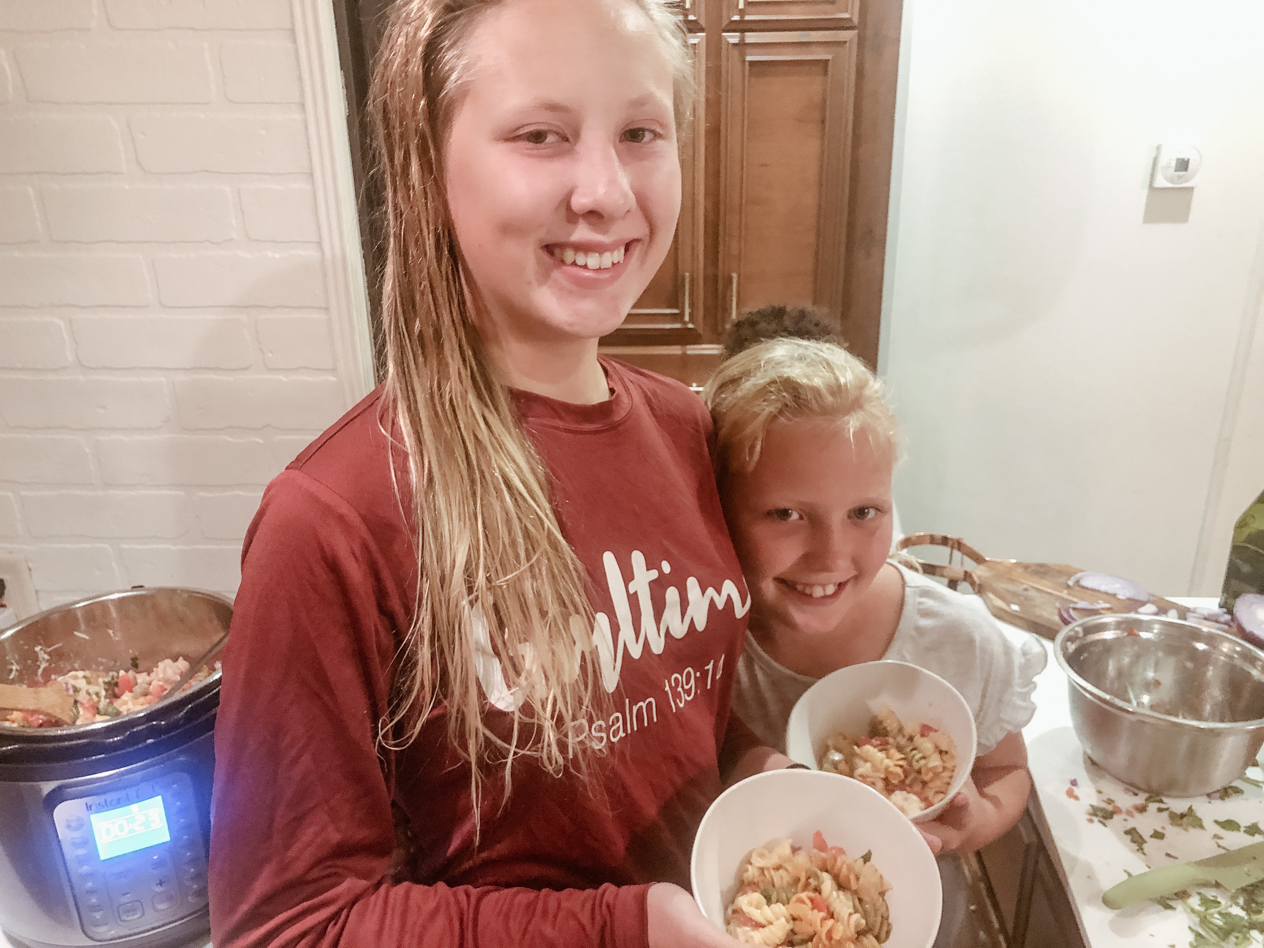 Shannon Carew's children hug as they grab some dinner inside their Highland Ridge RV.