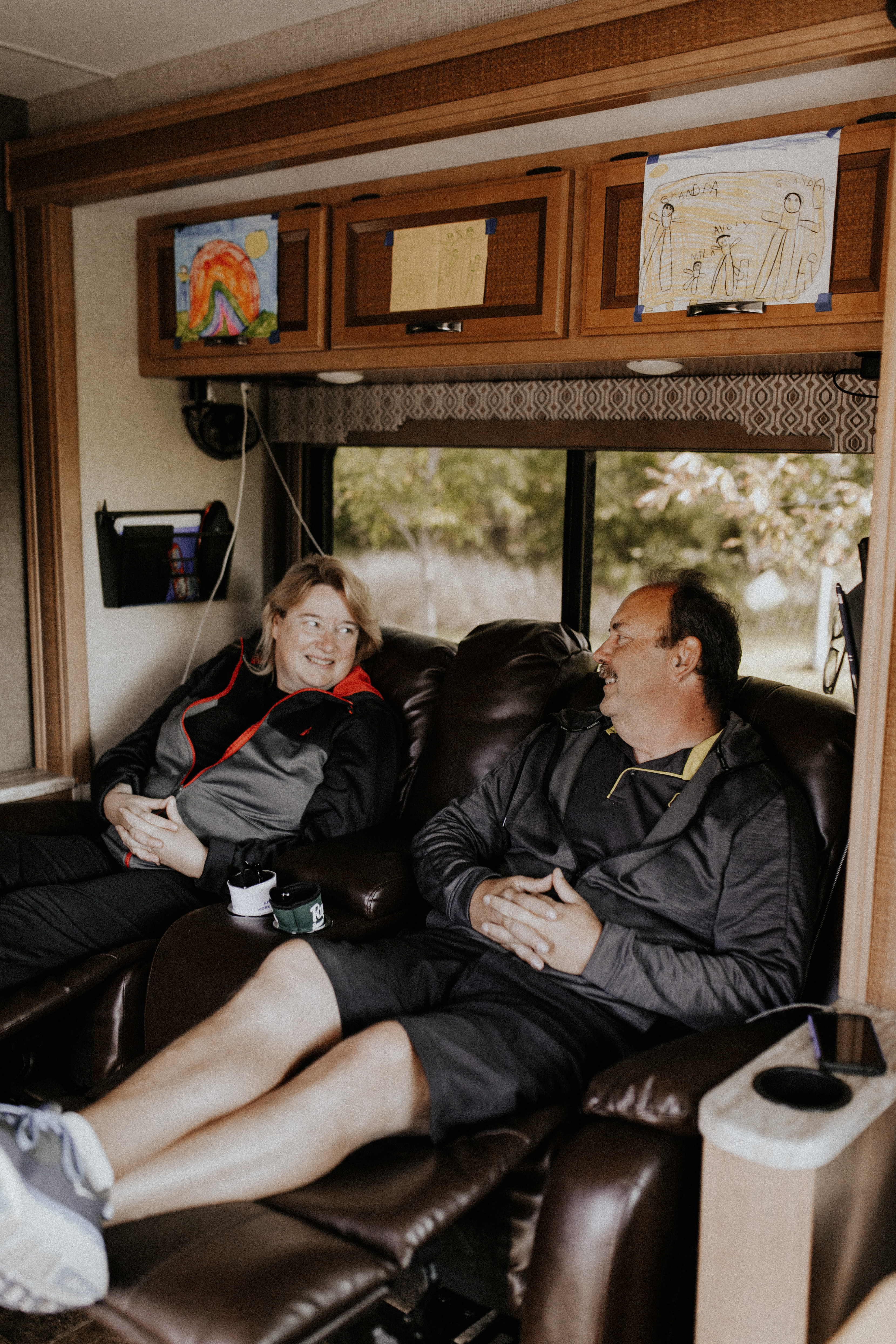 The Bolands putting their feet up in the recliner chairs inside their Thor Vegas RV.