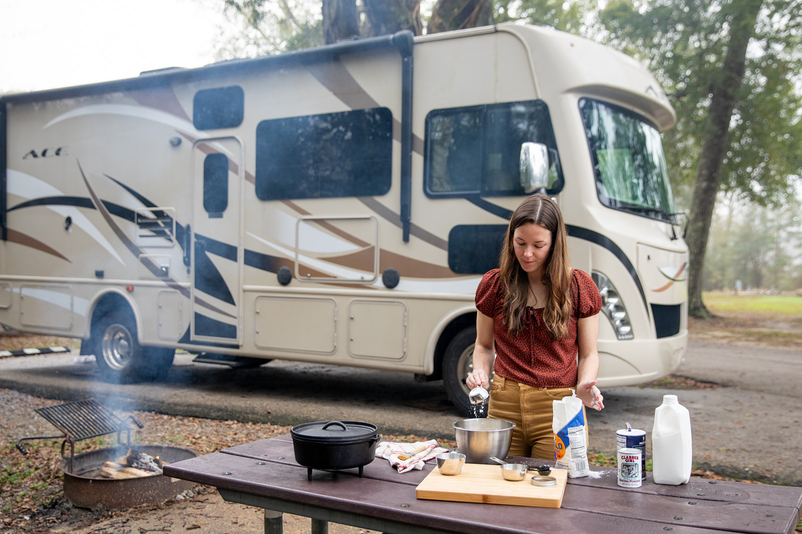 Adding flour to a bowl to make biscuits. 