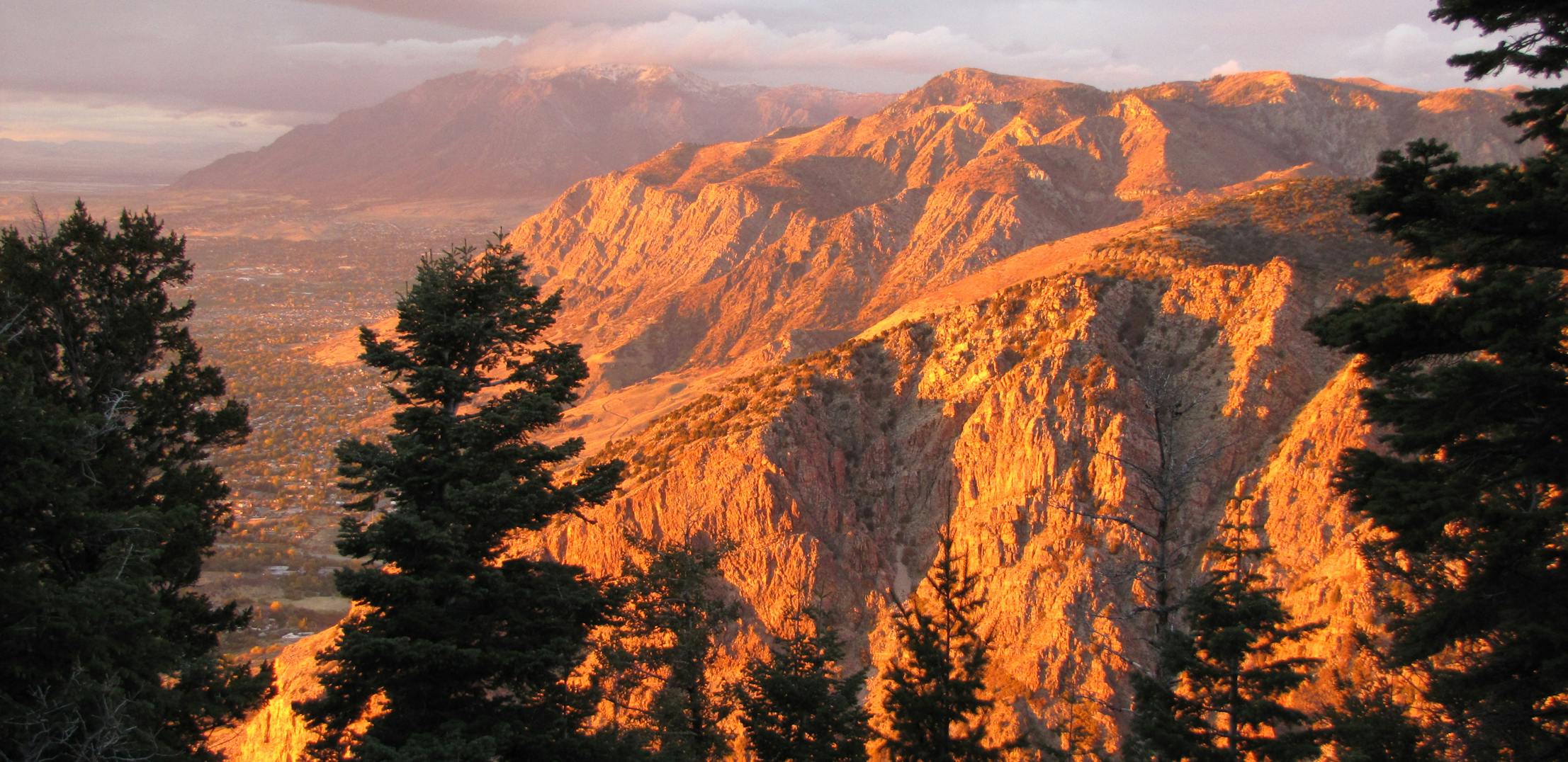A sunset pouring over a mountainside in Uinta-Wasatch-Cache National Forest.