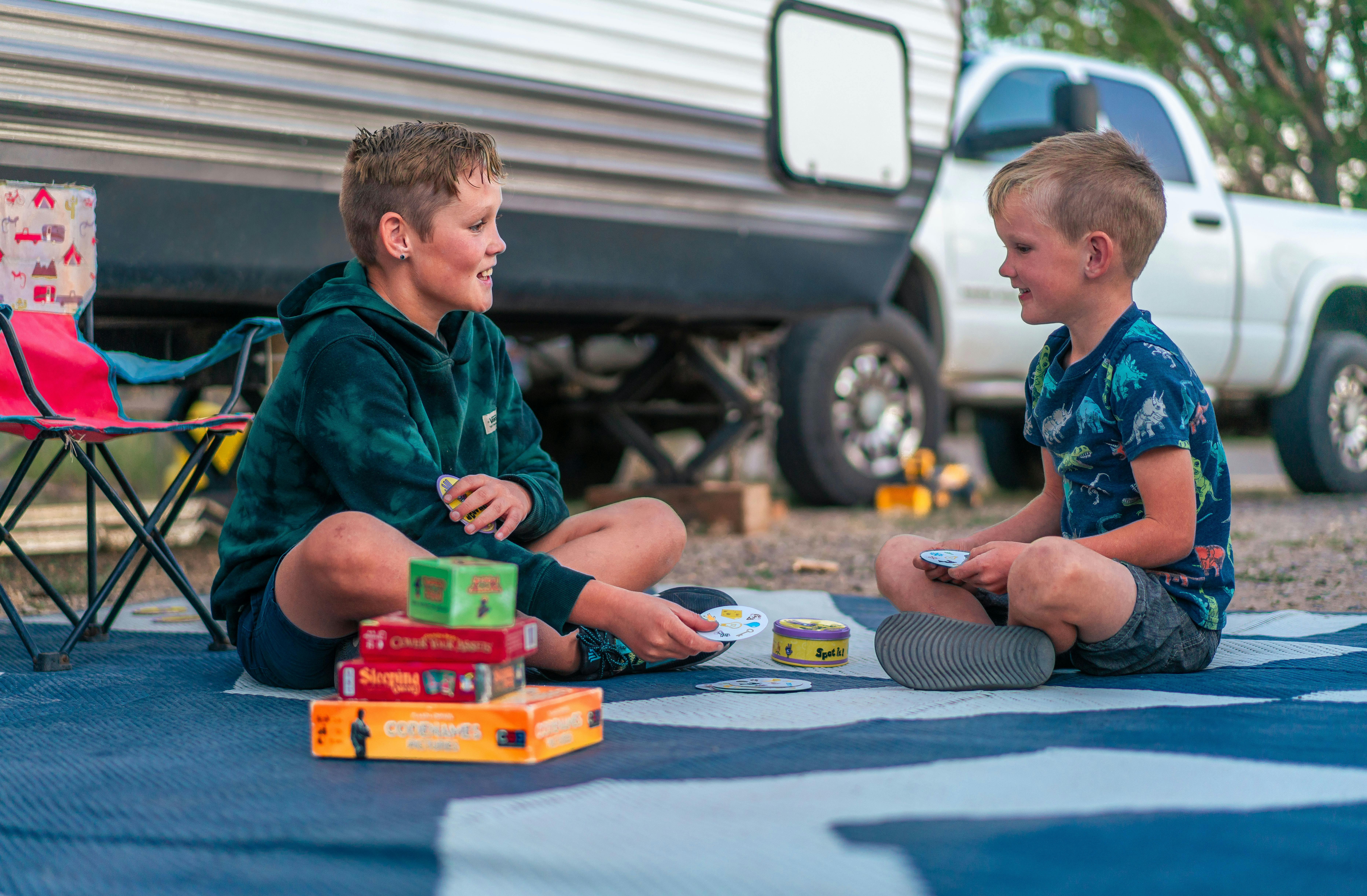 The Renee Tilby kids playing games outside of their Jayco Jay Flight Travel Trailer