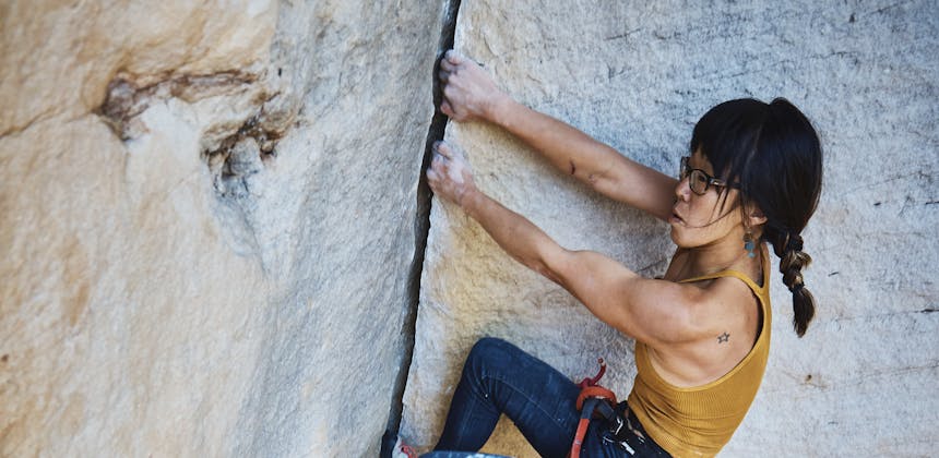 Kathy Karlo climbing up a mountain