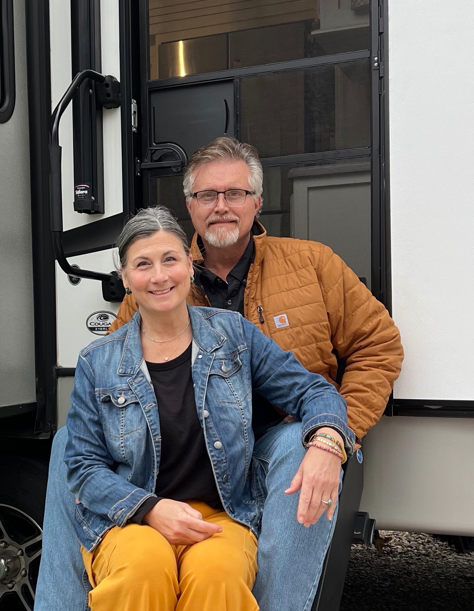 Donny and Tammy Benedict pose in front of their Keystone Cougar.