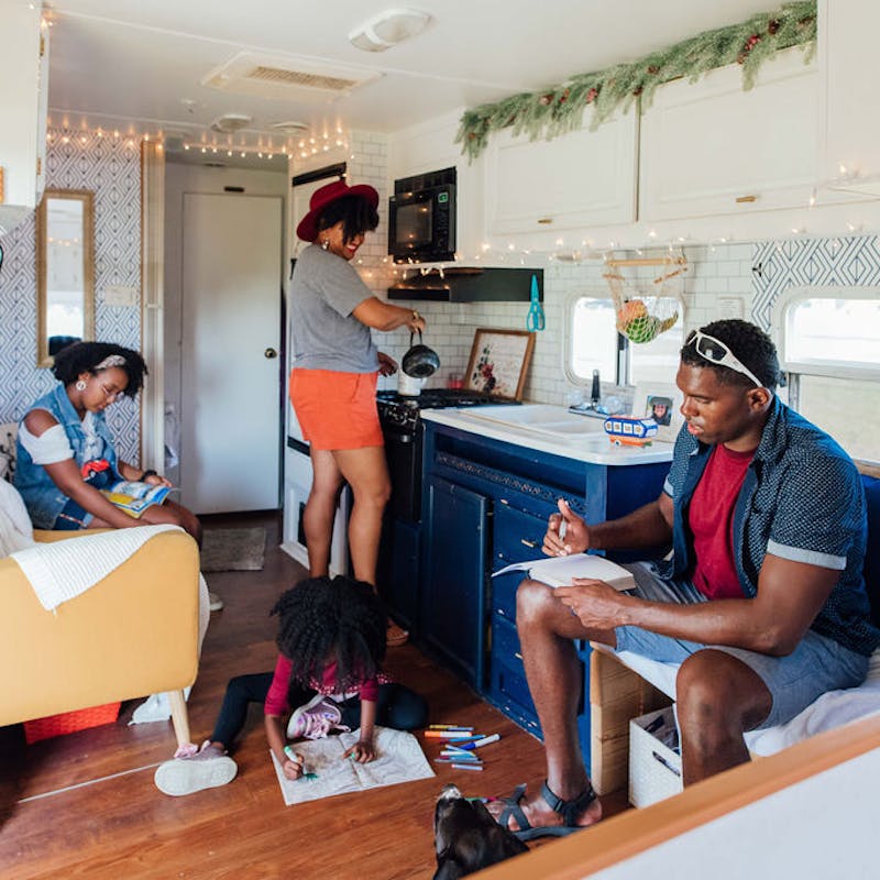 A family hanging out together in an RV living room.