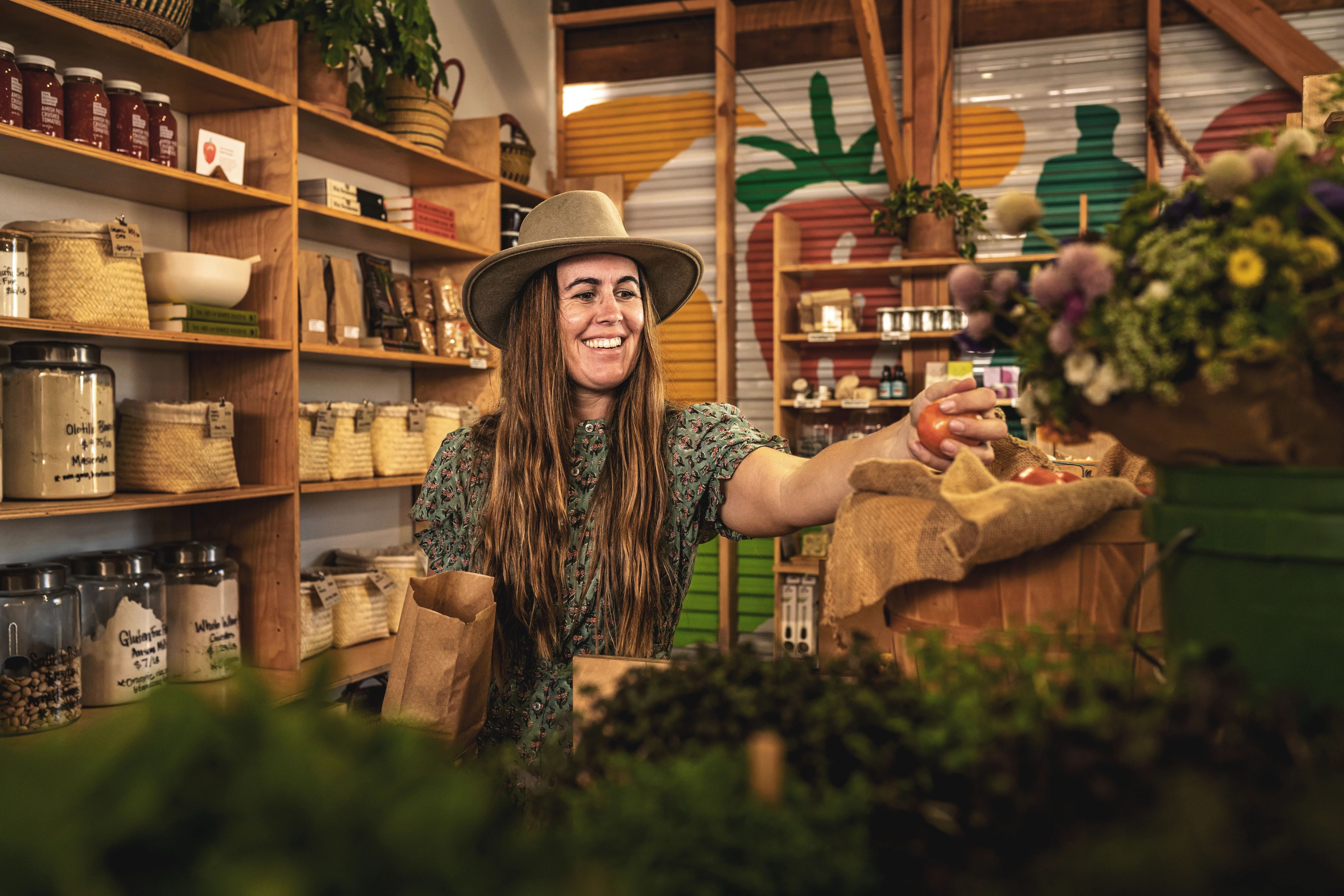 Sarah Glover picking out local produce at a farm stand