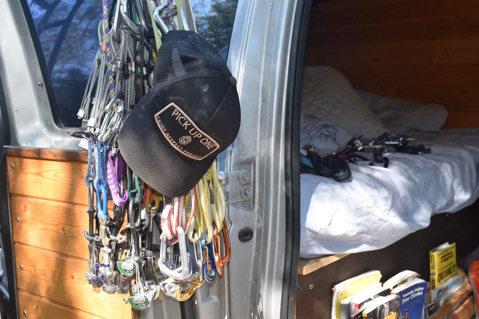 Hat and climbing gear and clips hanging on van