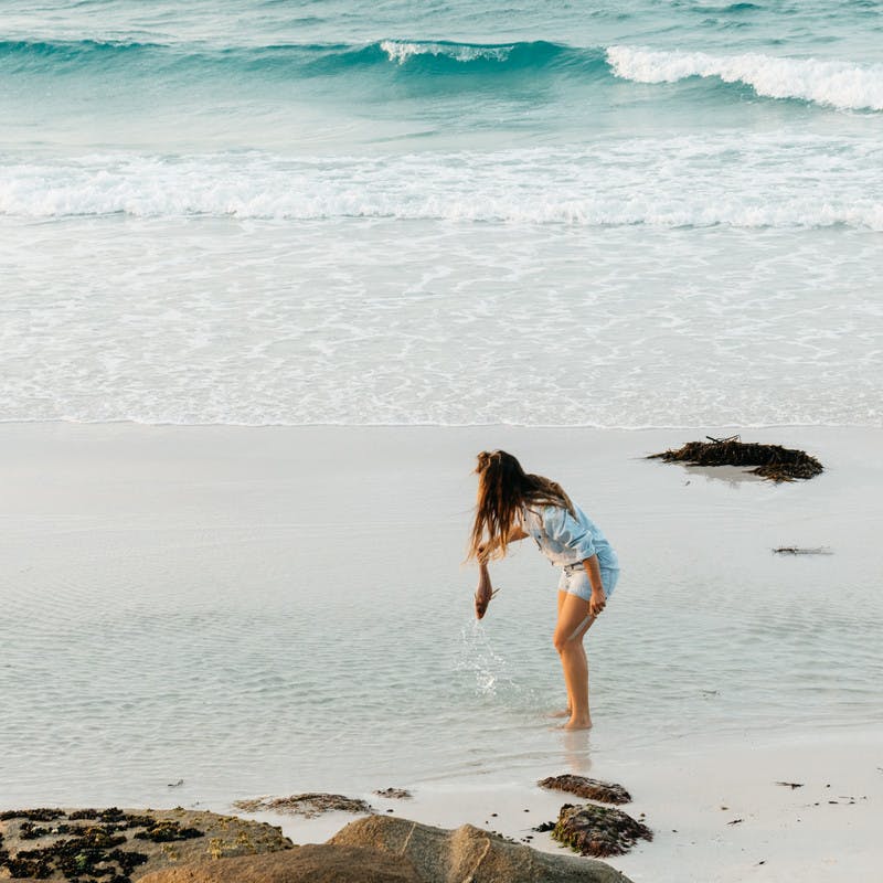 Sarah Glover with large knife pulling fish out of the ocean.