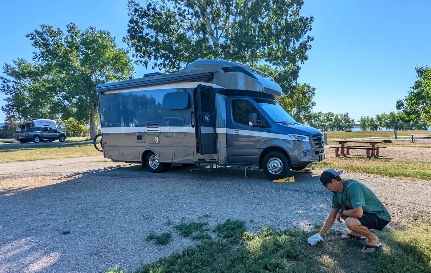 Dustin Bauer picking up garbage at his campsite 