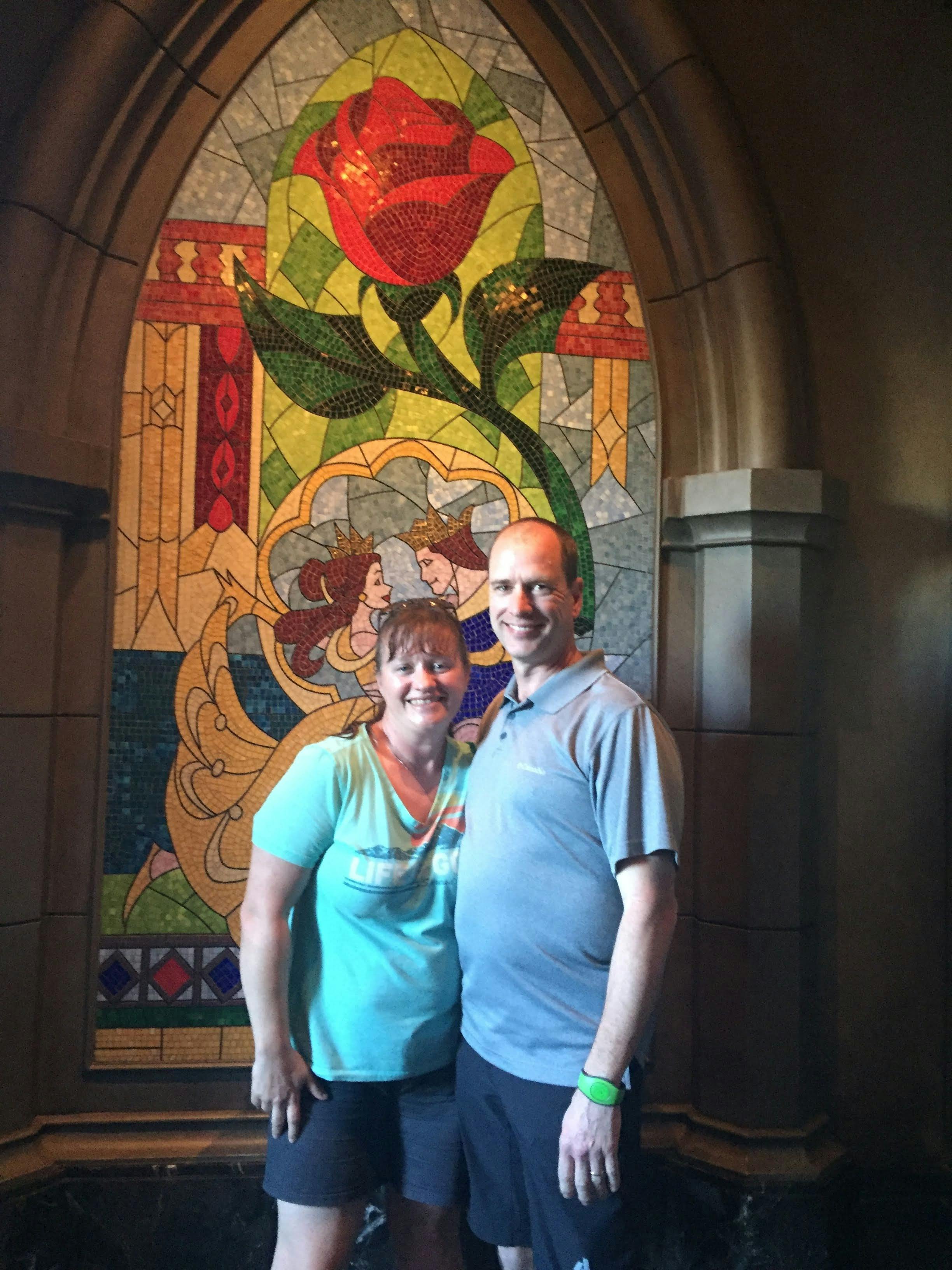 Brandy and Matt Gleason at Disney World in front of stained glass