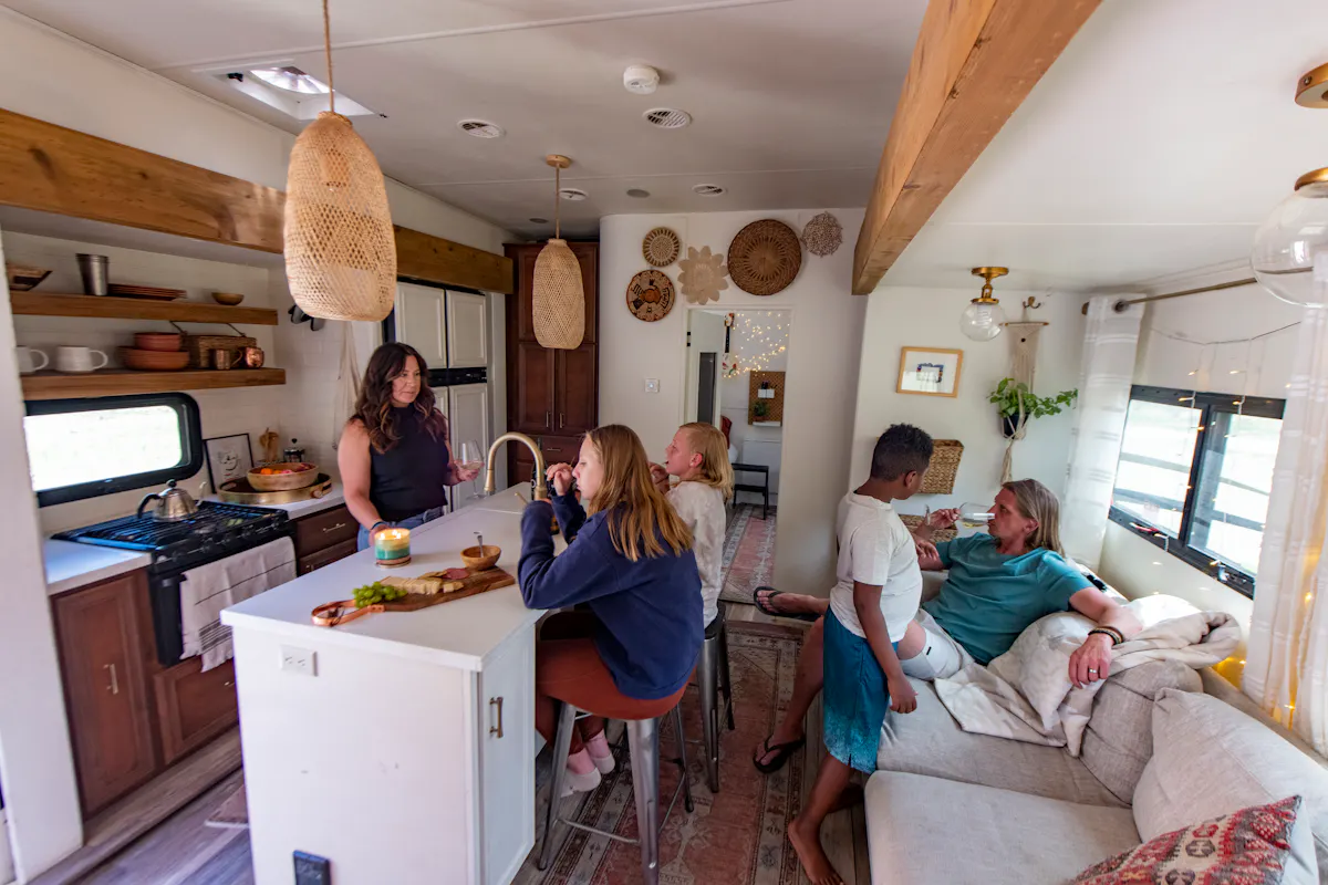 The Carew family relaxing inside the kitchen and living area of their RV