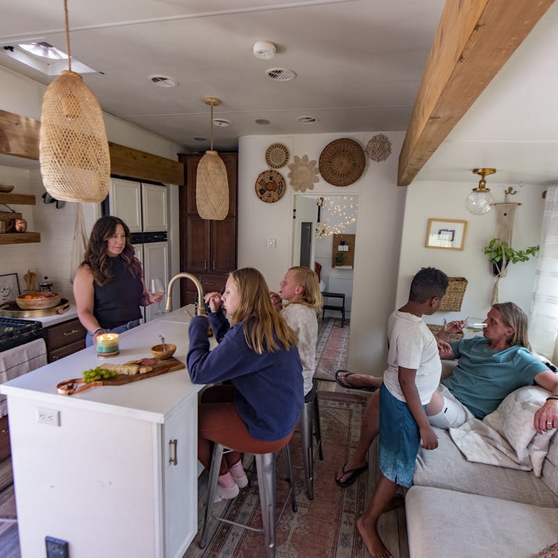 The Carew family relaxing inside the kitchen and living area of their RV