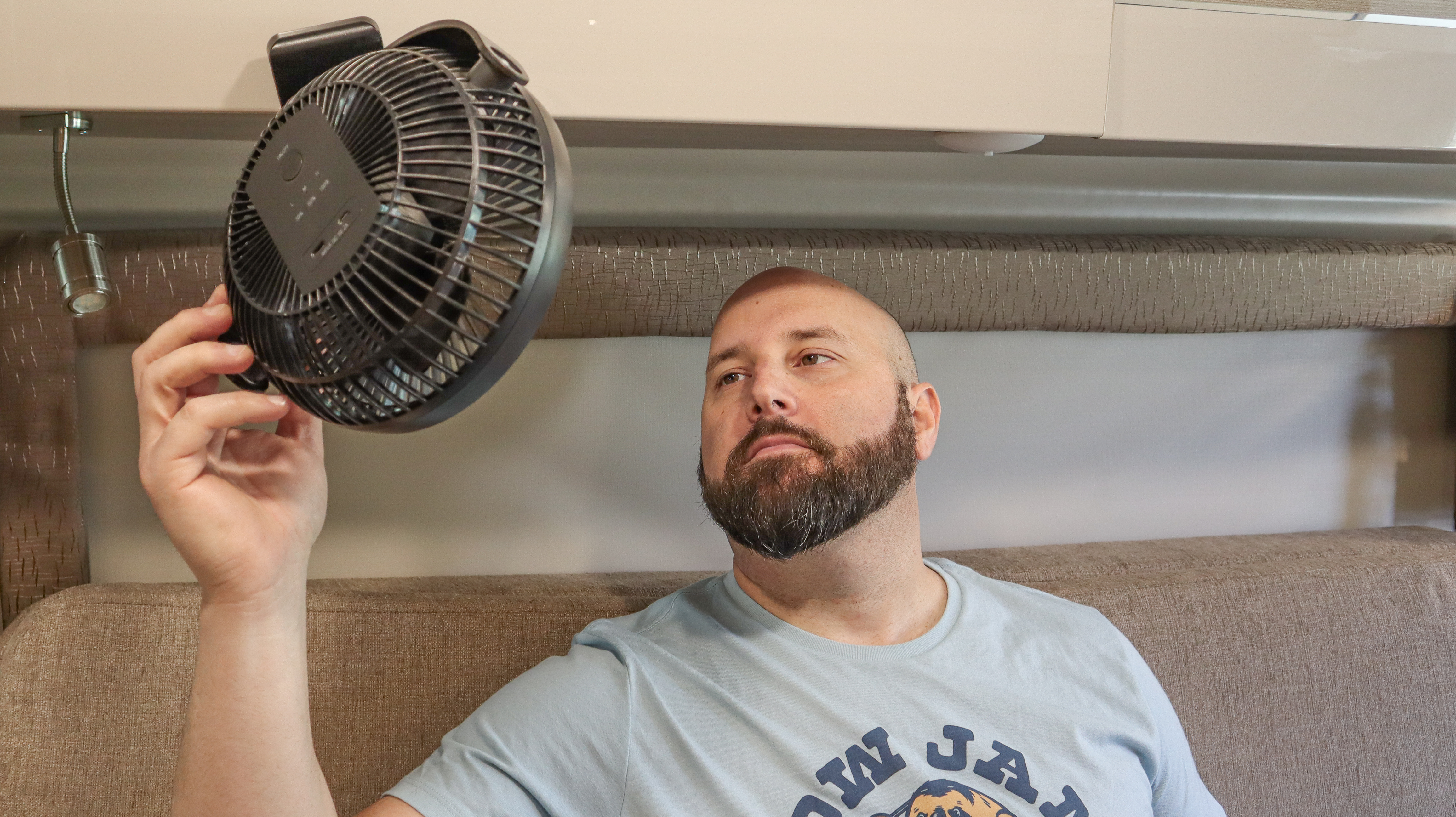Gabe fanning himself with a small battery powered fan