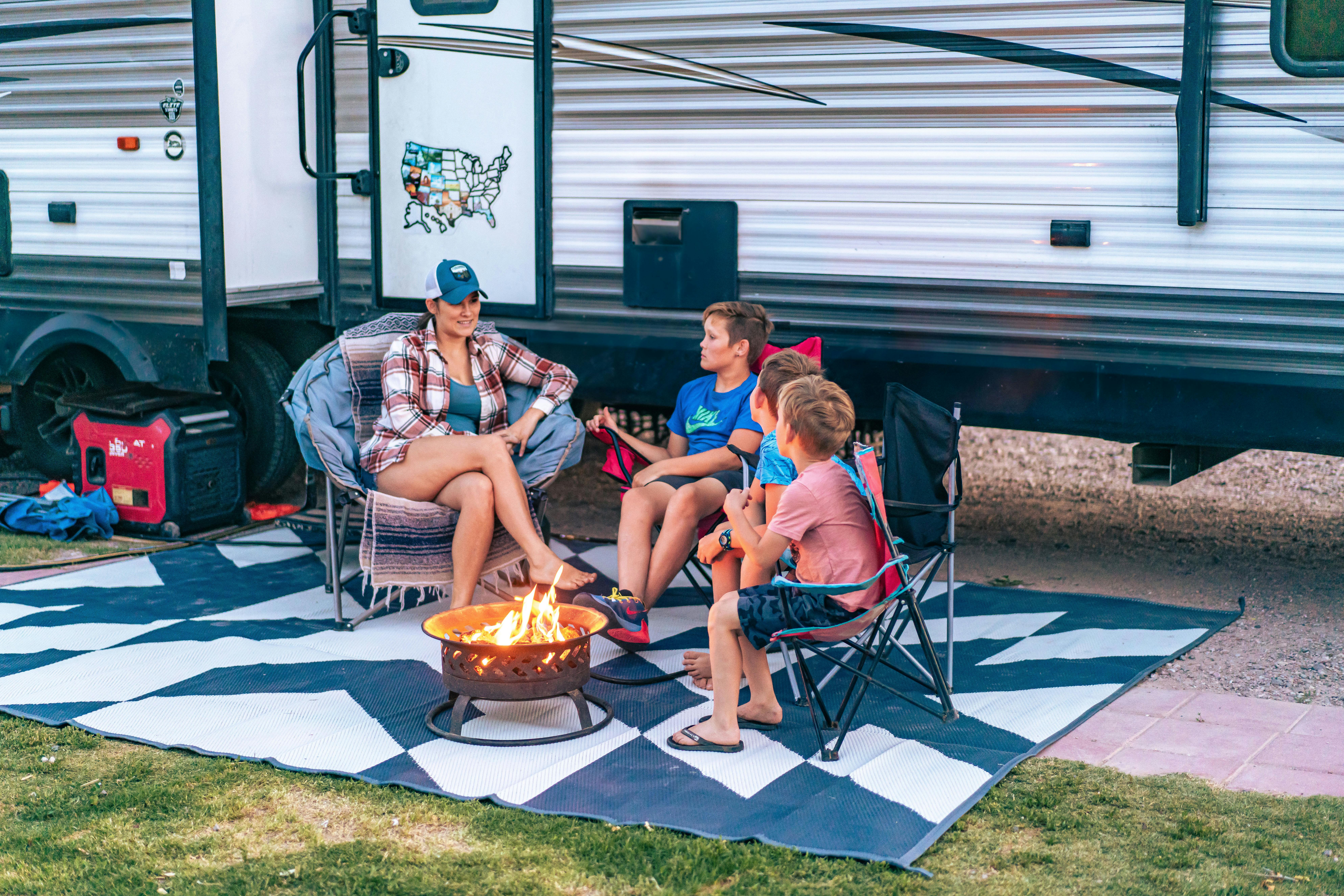 The Renee Tilby family sitting around a campfire outside of their Jayco Jay Flight Travel Trailer