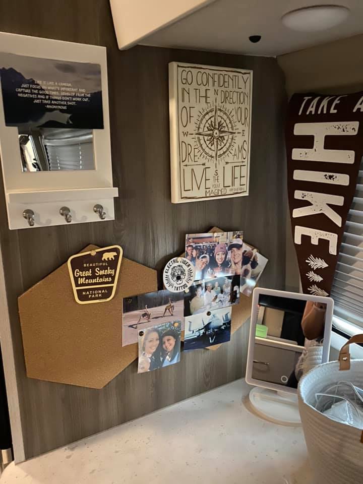 A wall in Jess Lawson's Thor Motor Coach Tellaro with photos and memorabilia from places she has visited.  